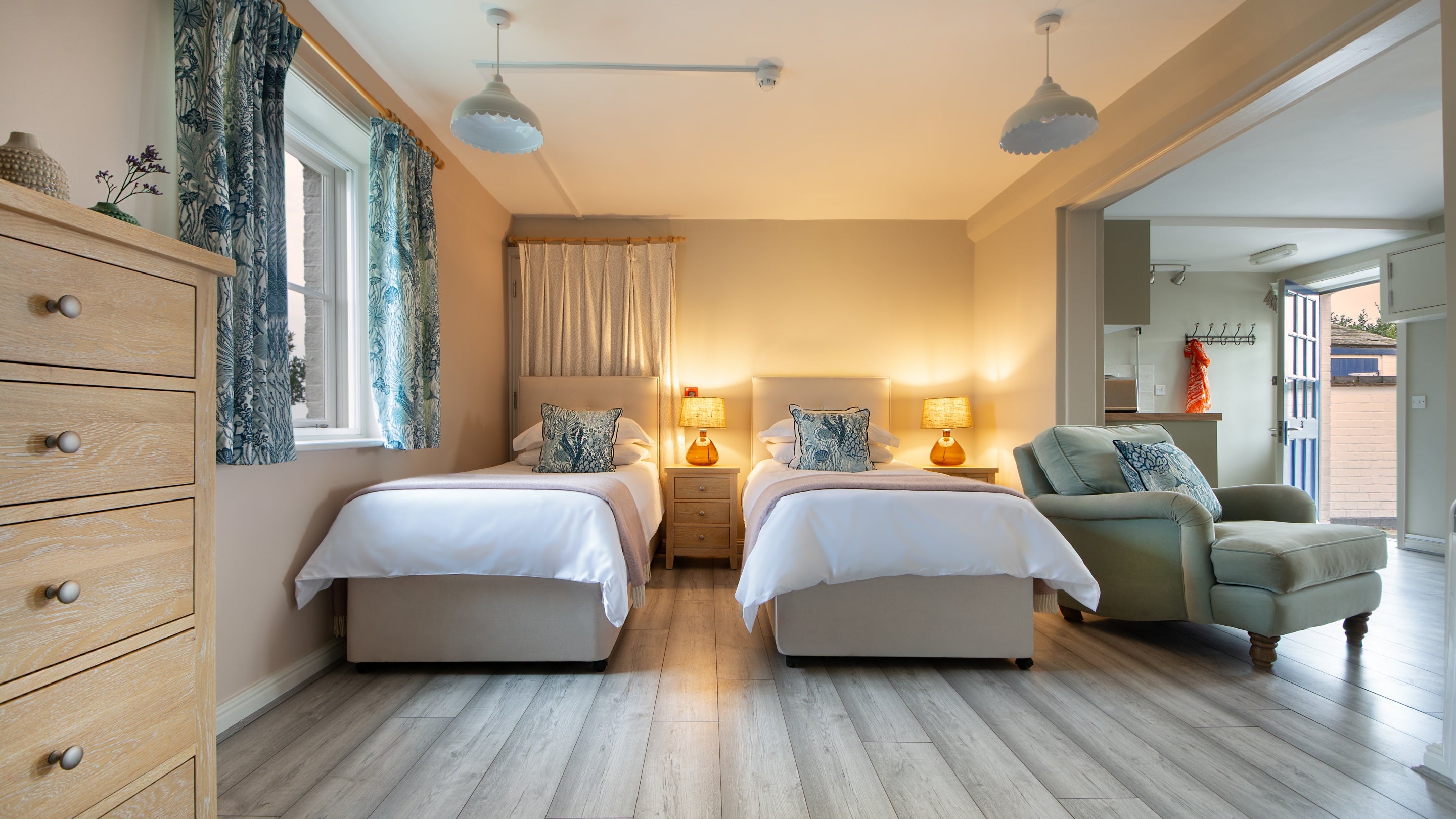 The twin beds in the open plan bedroom, kitchen and seating area of Nightjar, Suffolk