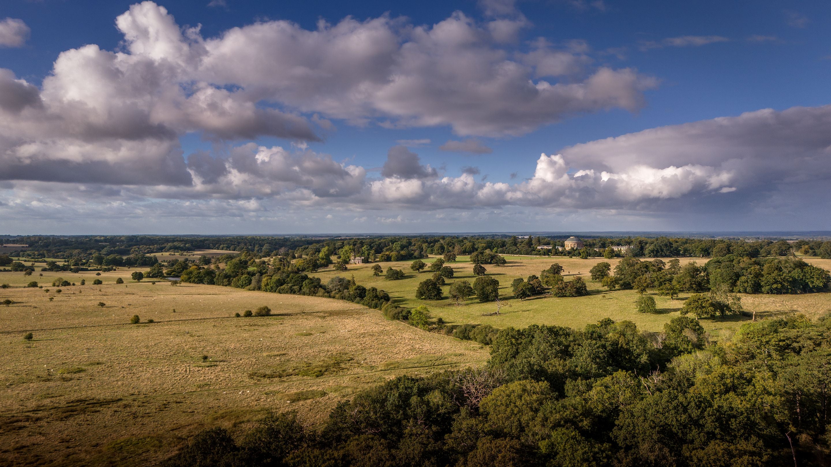 An aerial view of the Ickworth Estate parkland, with the Rotunda, St Mary’s Church and River Linnet in the distance, Suffolk