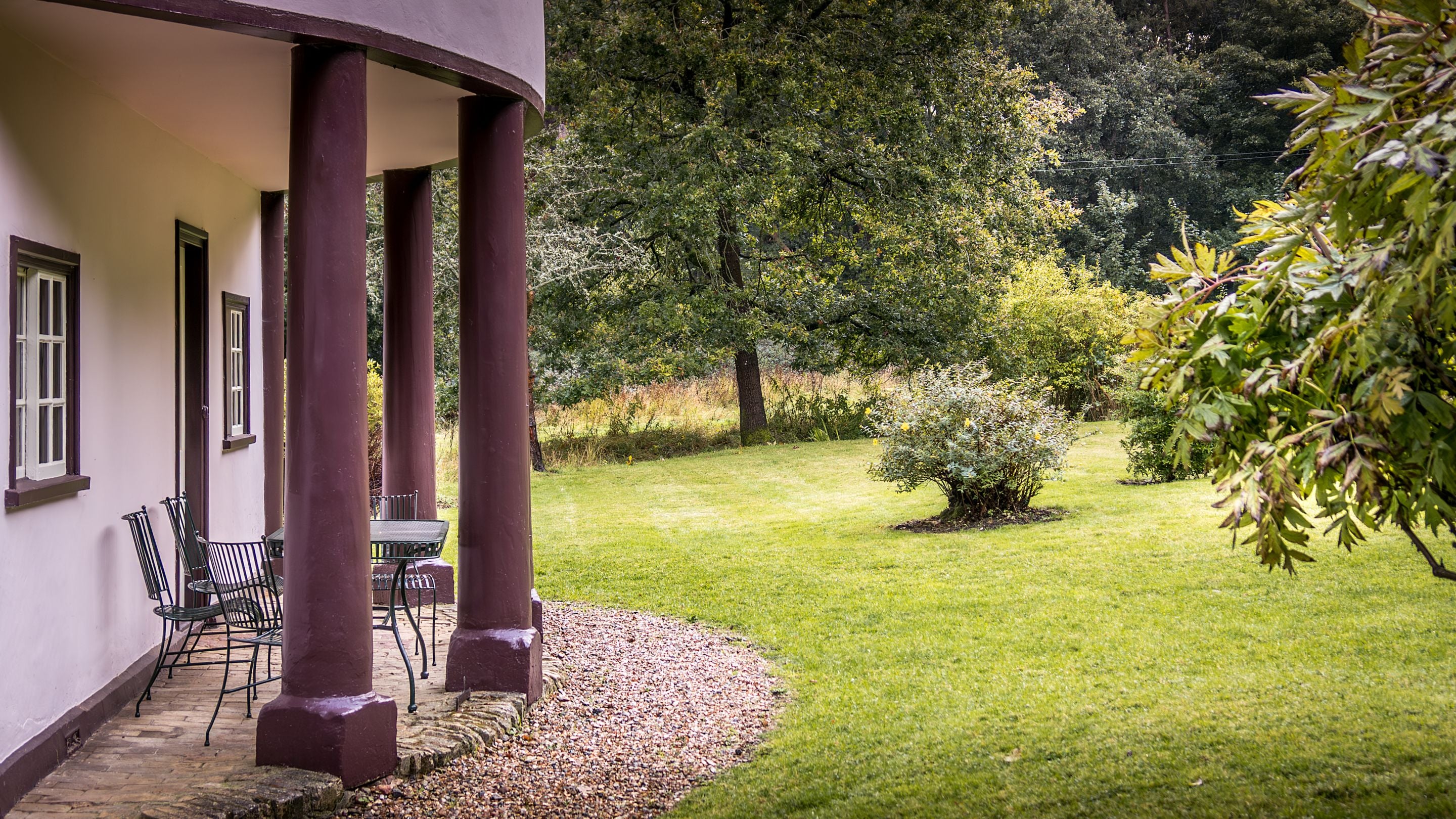 The portico, covered patio and garden lawn at The Round House, Suffolk