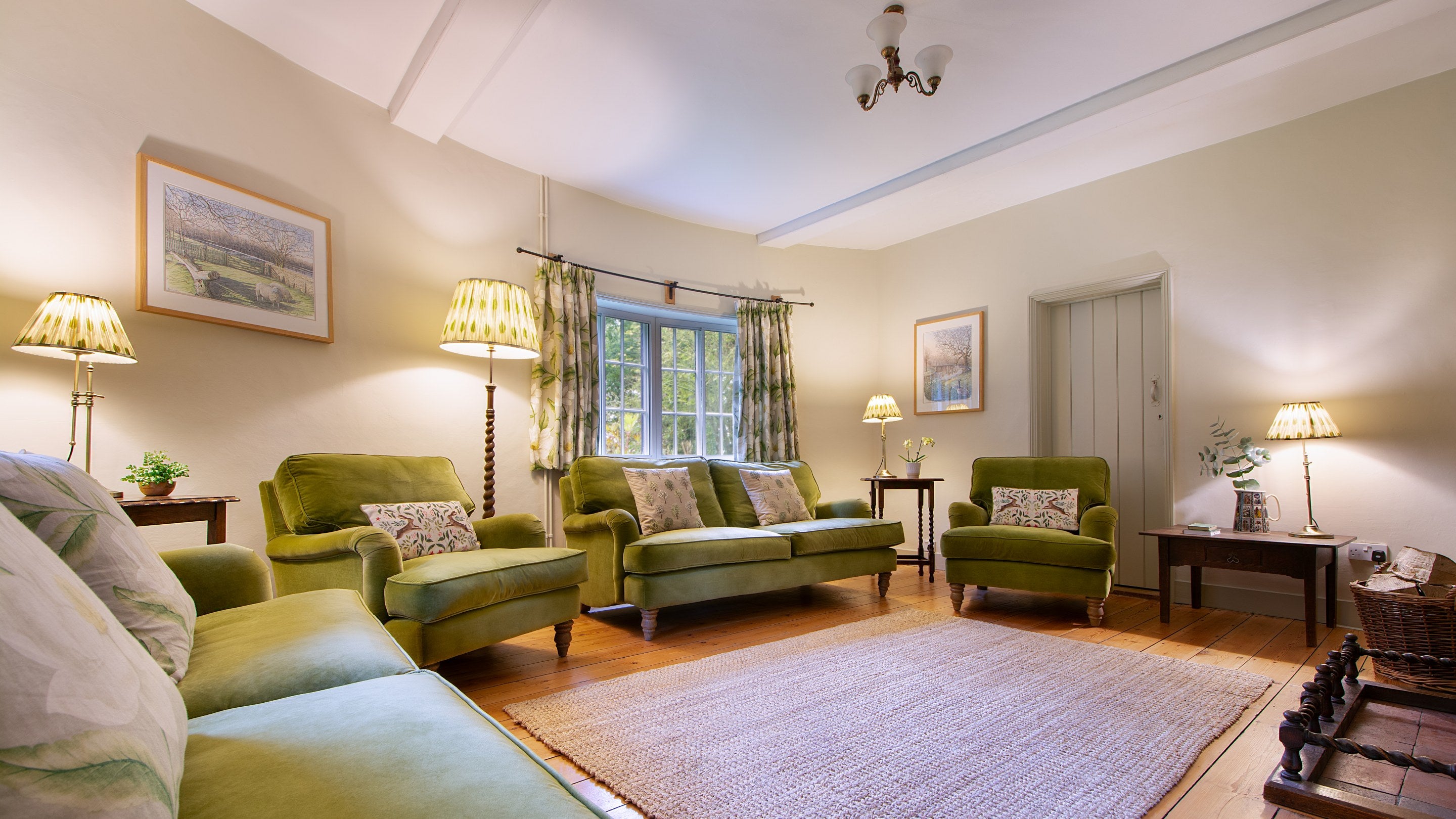 The sitting room at The Round House, with sofas and armchairs, and a curved outer wall, Suffolk