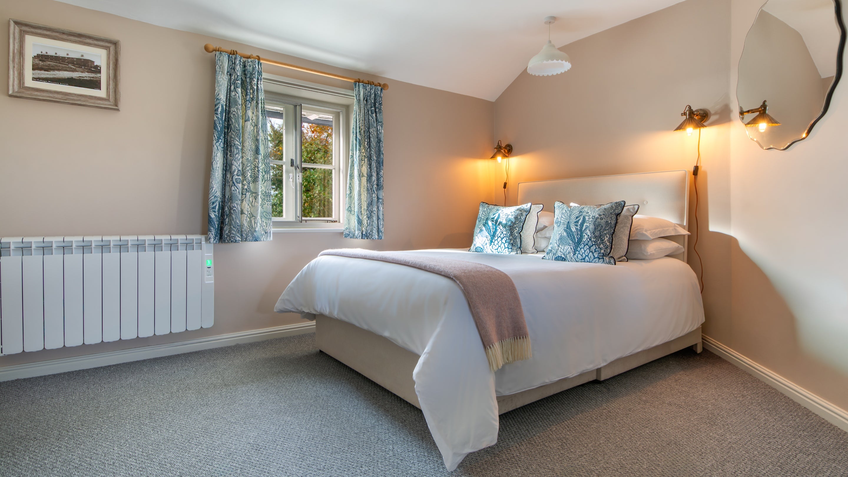 The double bed at Stonechat in the open plan bedroom, kitchen and seating area, Suffolk