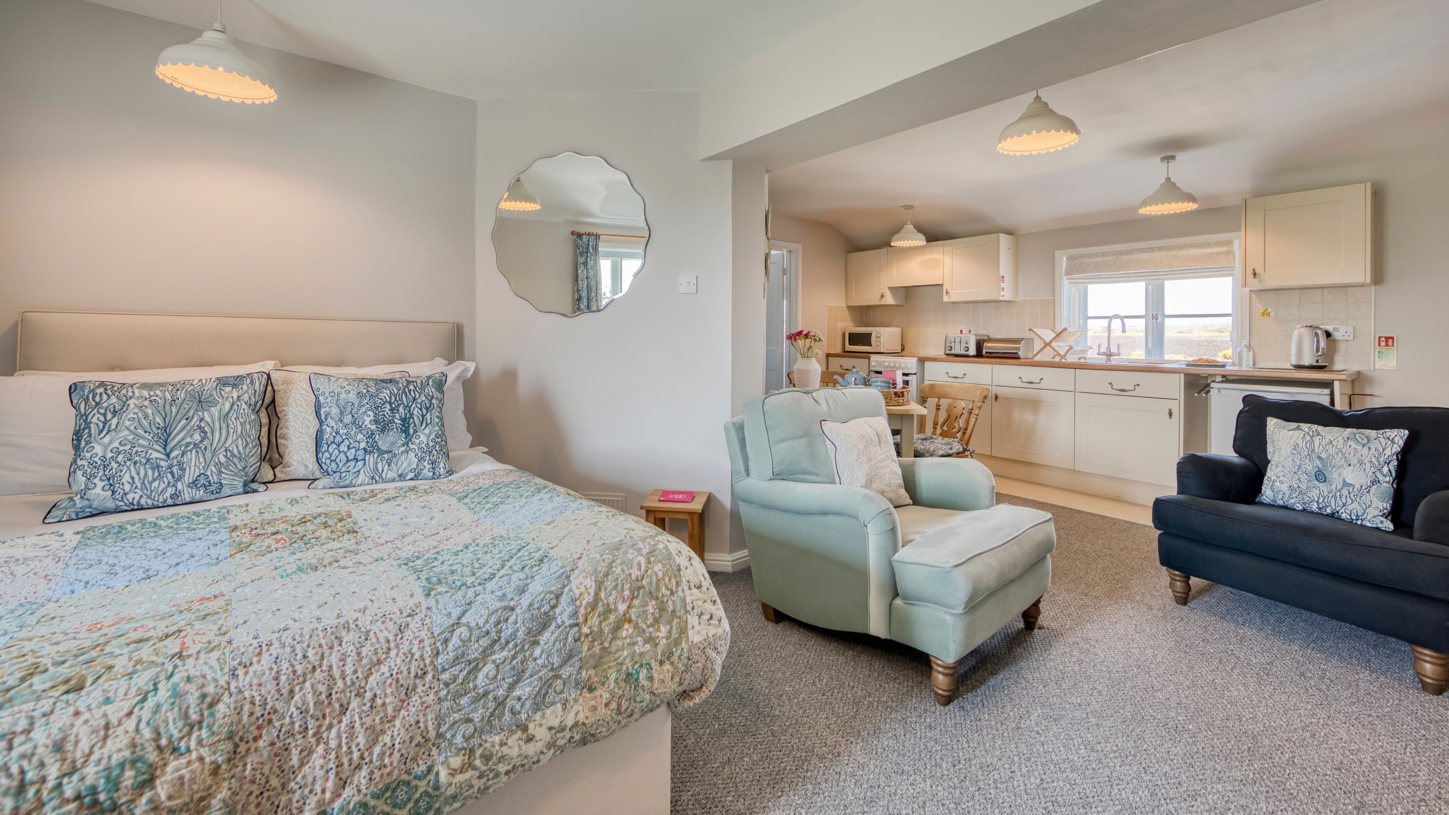 The bedroom and seating area at Stonechat, Suffolk