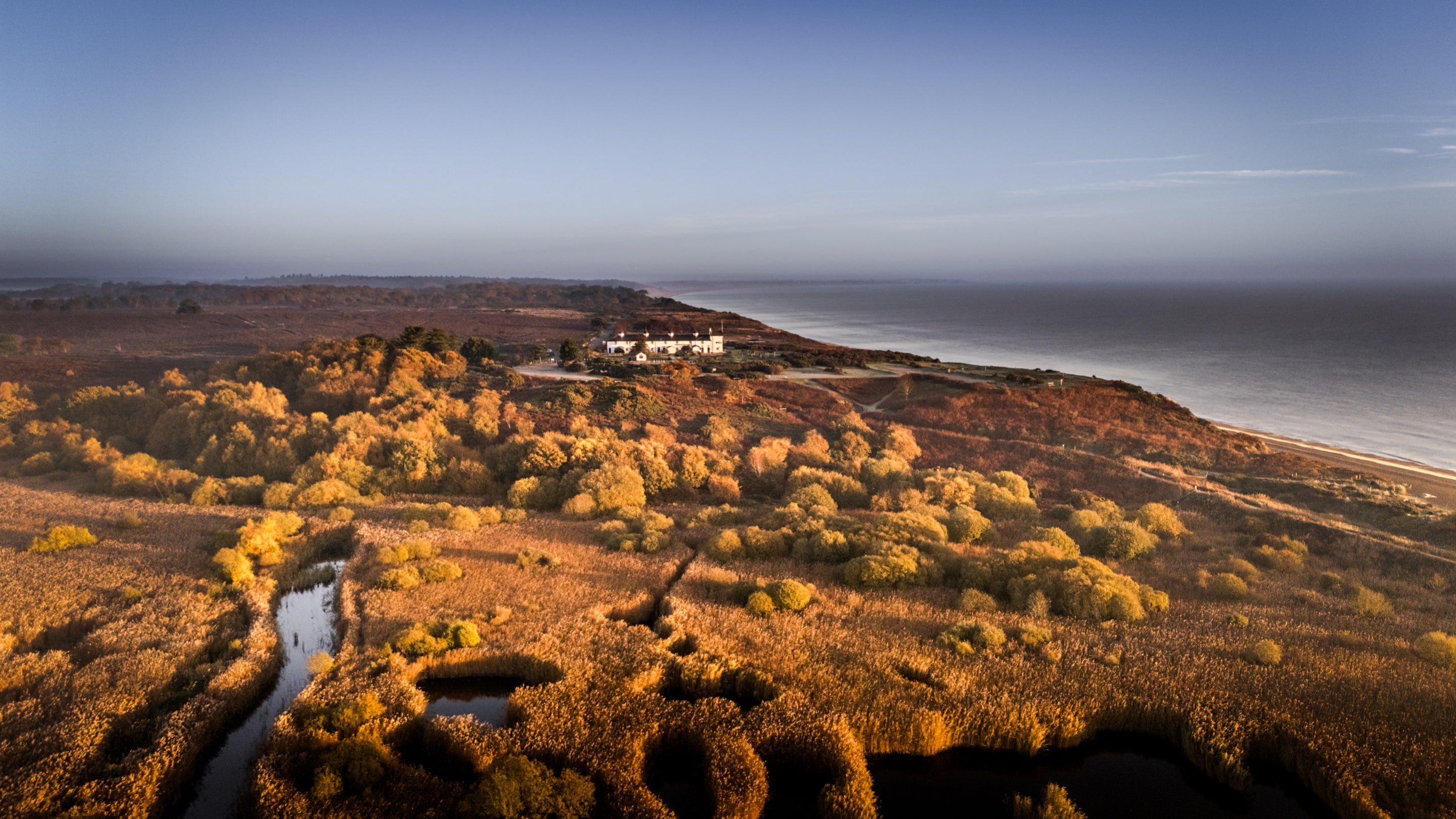The exterior of Stonechat, Nightjar and Woodlark and the surrounding area of Dunwich Heath and beach