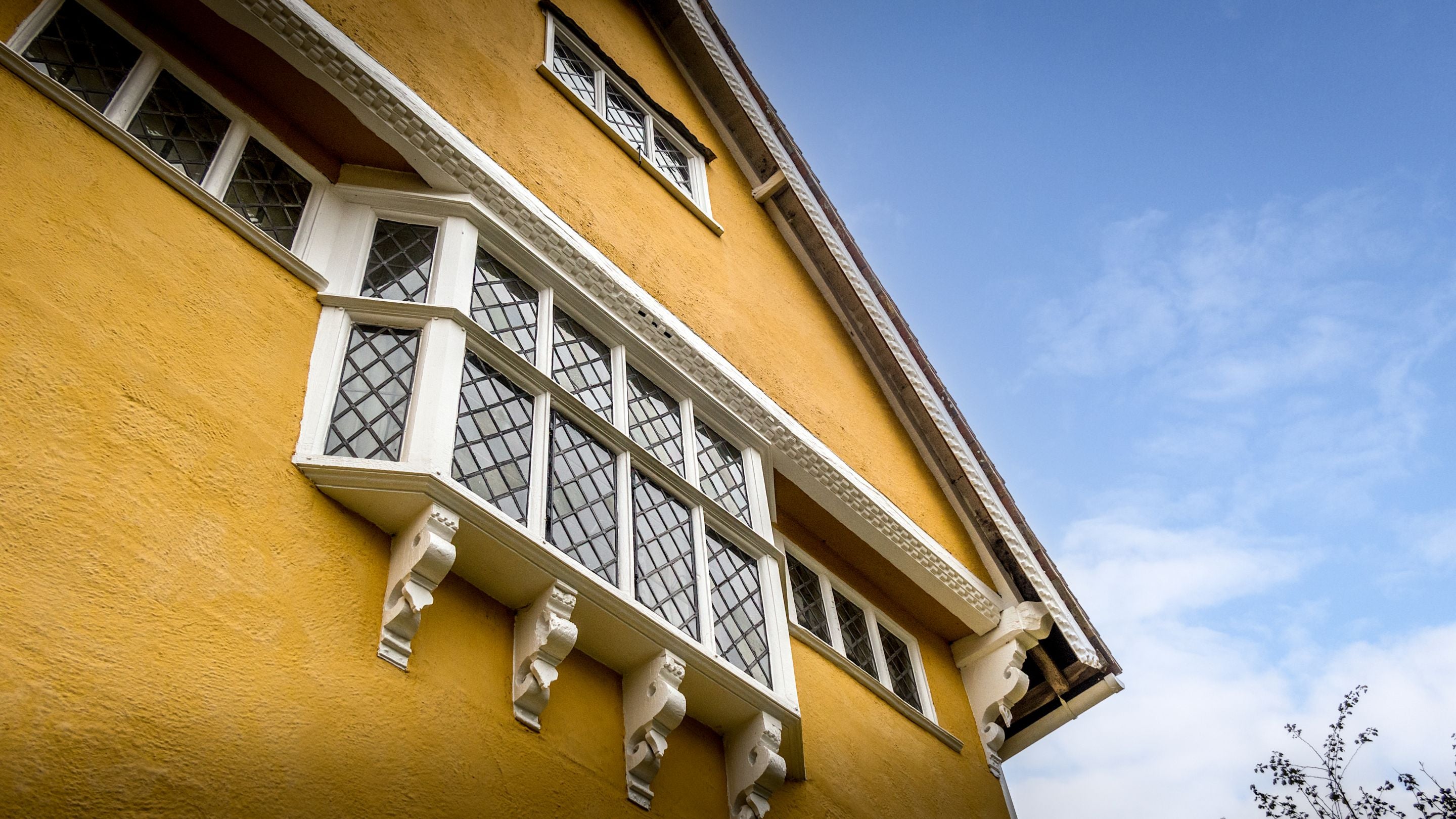 Looking up at the first and second-floor windows of Thorington Hall, Suffolk