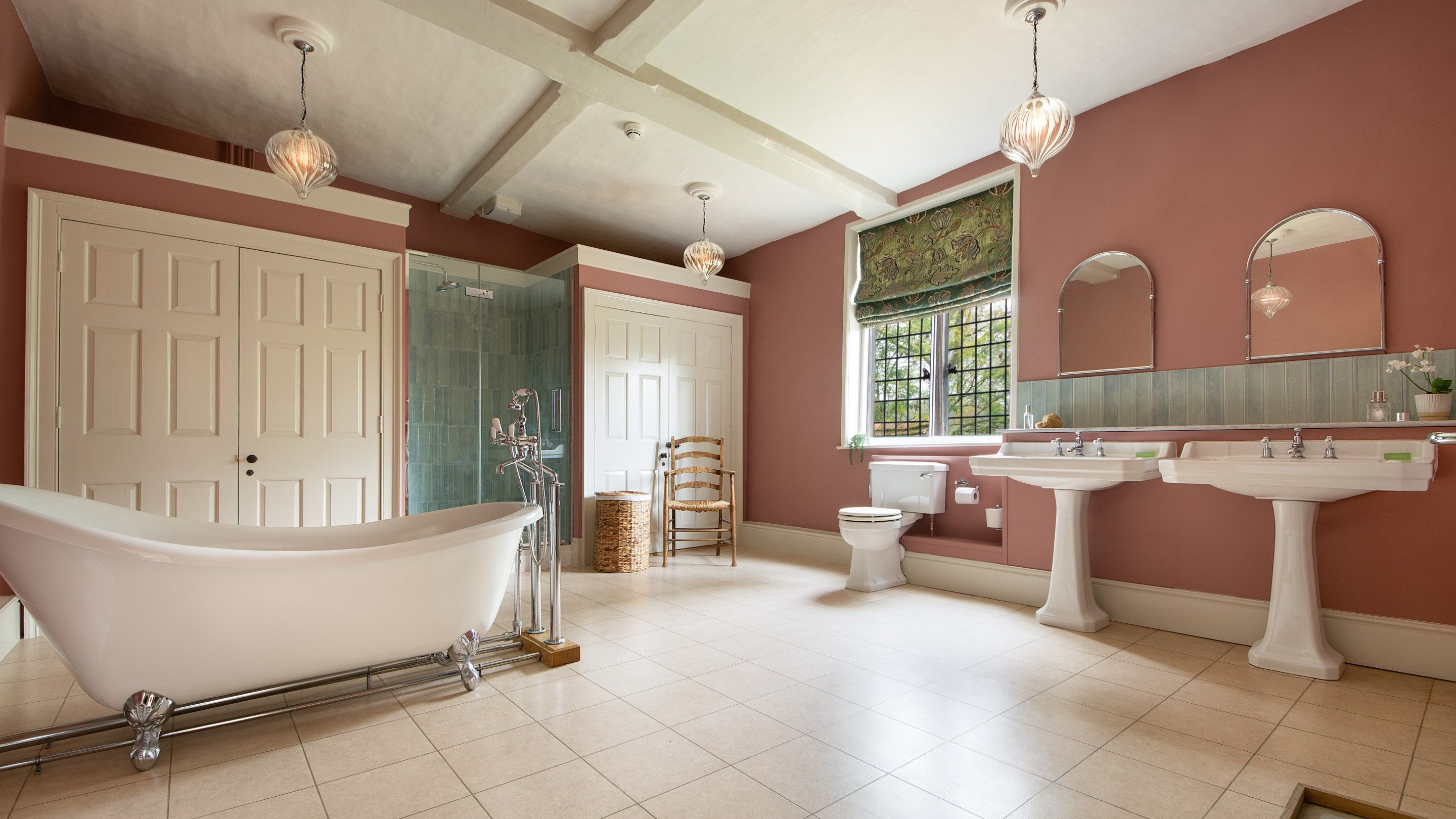 The first-floor bathroom, with roll-top bath and walk-in shower, at Thorington Hall, Suffolk