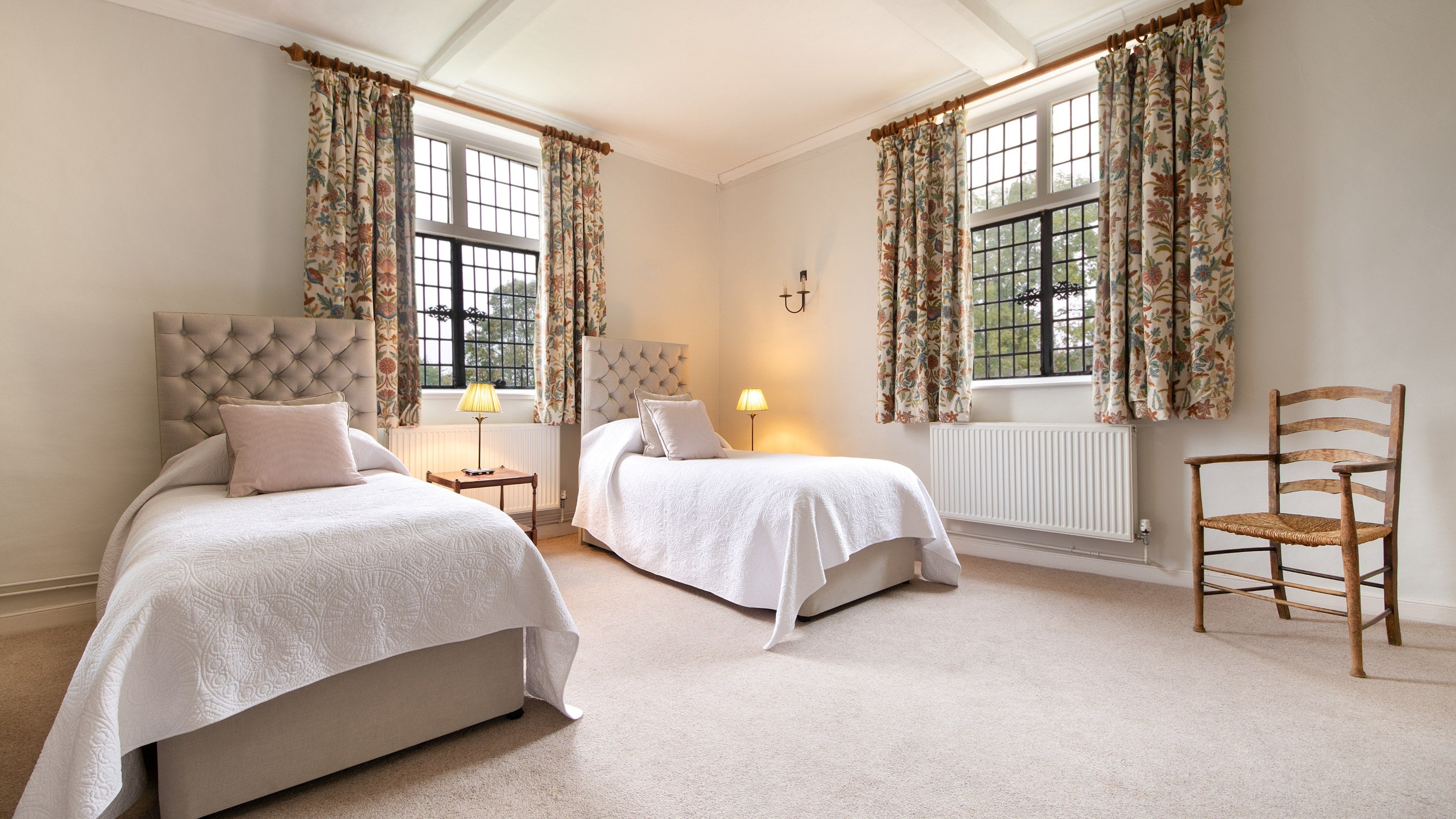 Bedroom 1 'Rosier,' with twin beds, on the first floor of Thorington Hall, Suffolk