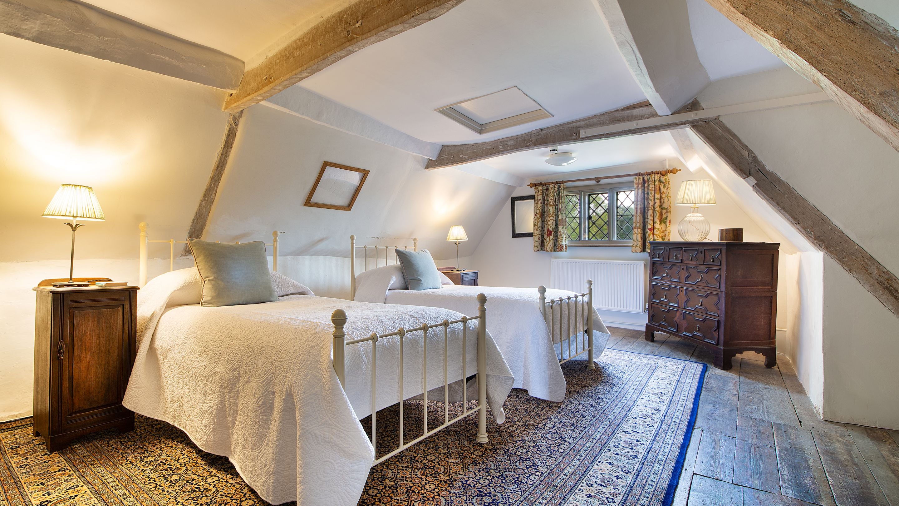 Bedroom 4 'Umfreville,' with twin beds, on the second floor of Thorington Hall, Suffolk