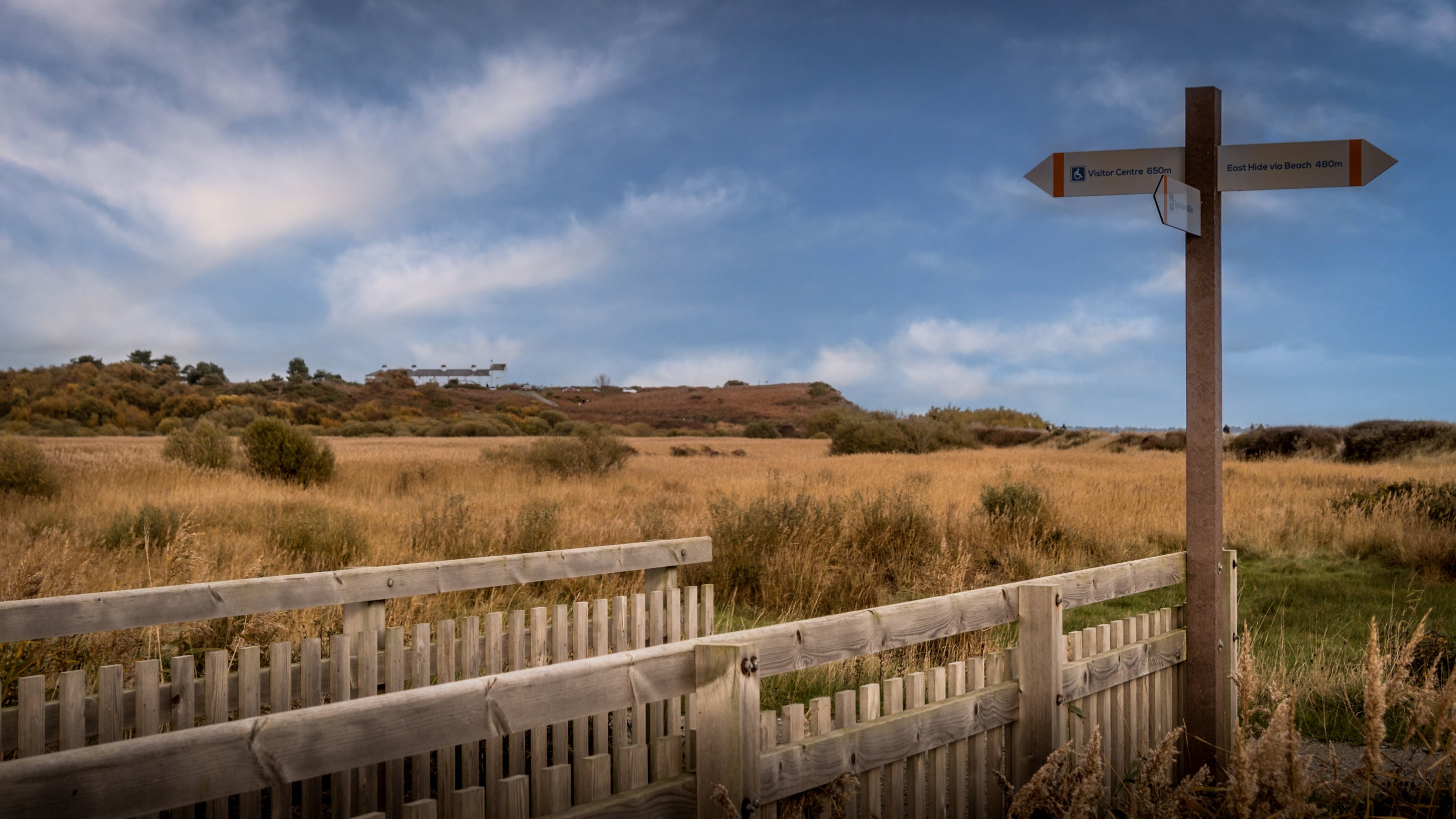 The exterior of Woodlark, Stonechat and Nightjar surrounded by Dunwich Heath and visitor signs, Suffolk