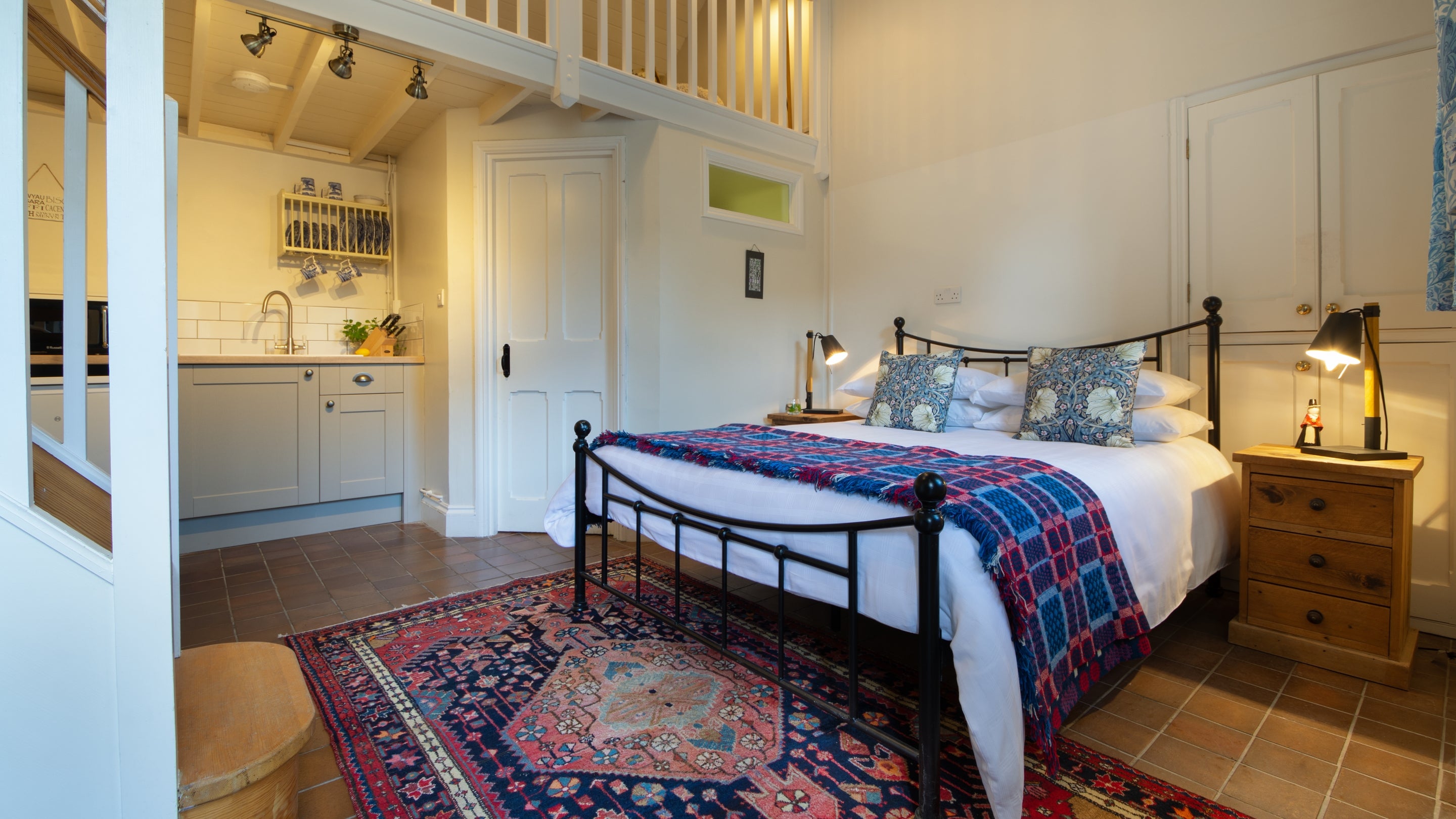 The ground floor open plan area with the bed and kitchen area at Aran, Gwynedd