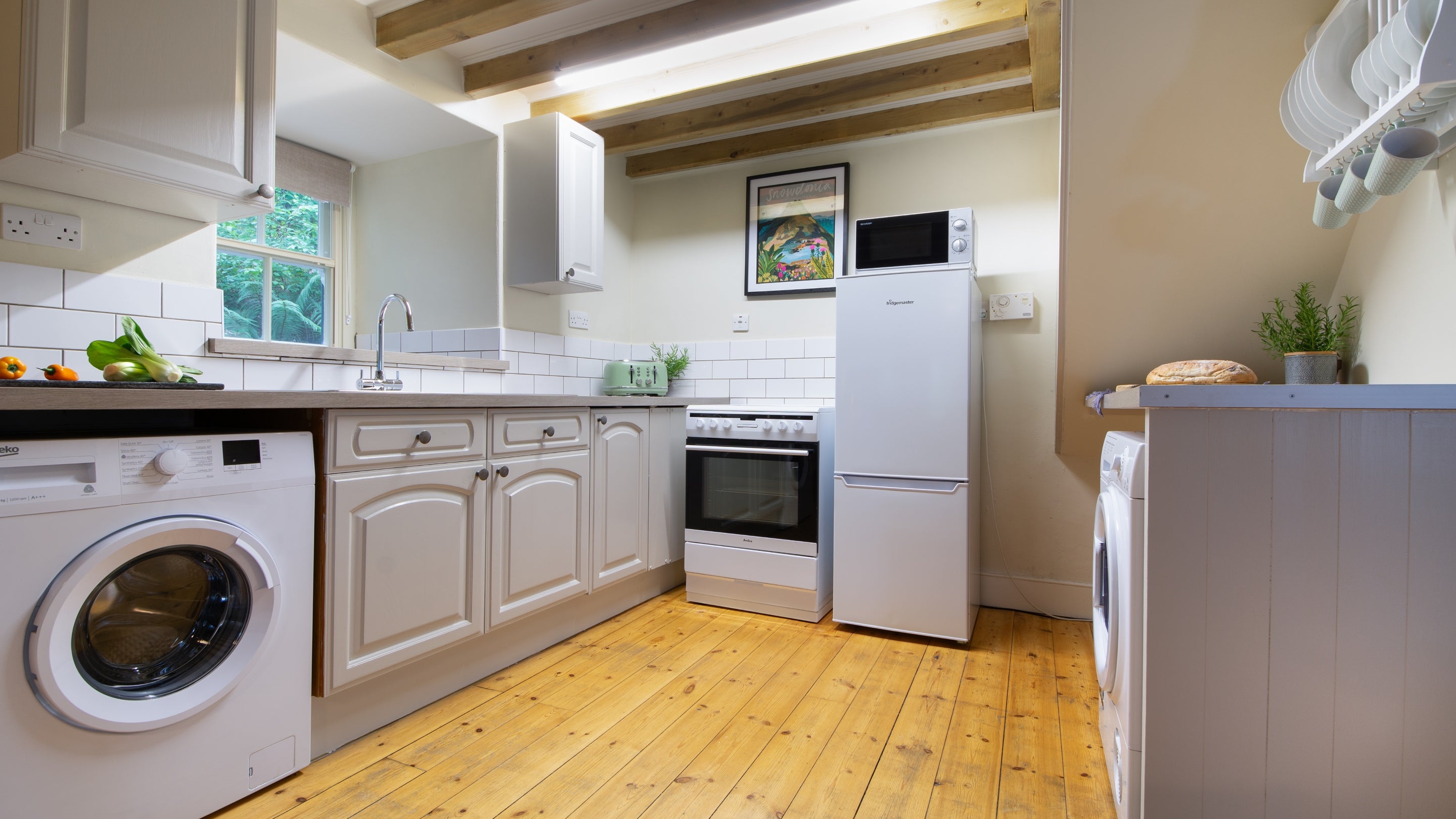 The open plan kitchen, sitting and dining room at Bwthyn Mai, Gwynedd