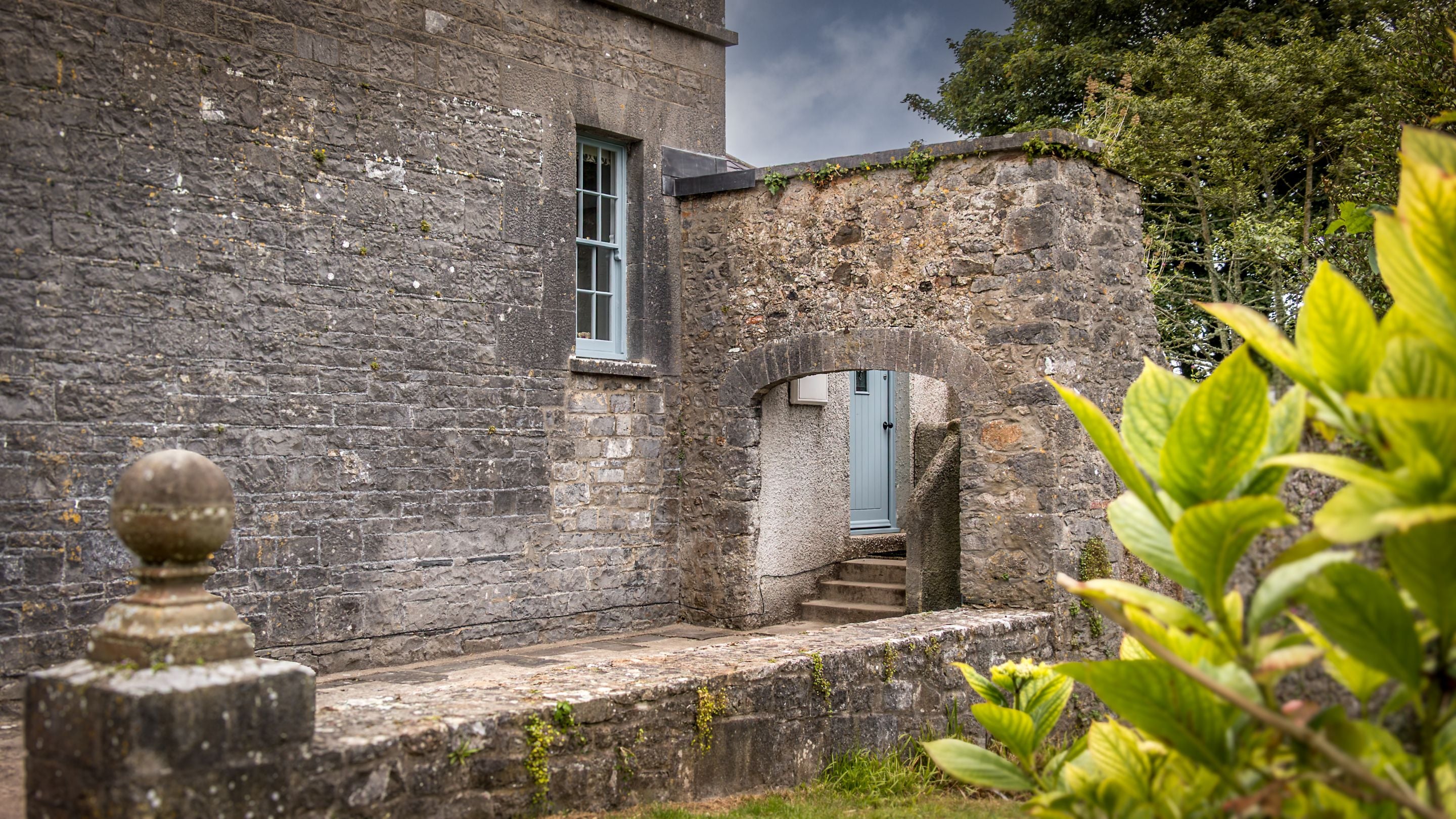 The path underneath a stone archway and steps to Cawdor's door, Pembrokeshire