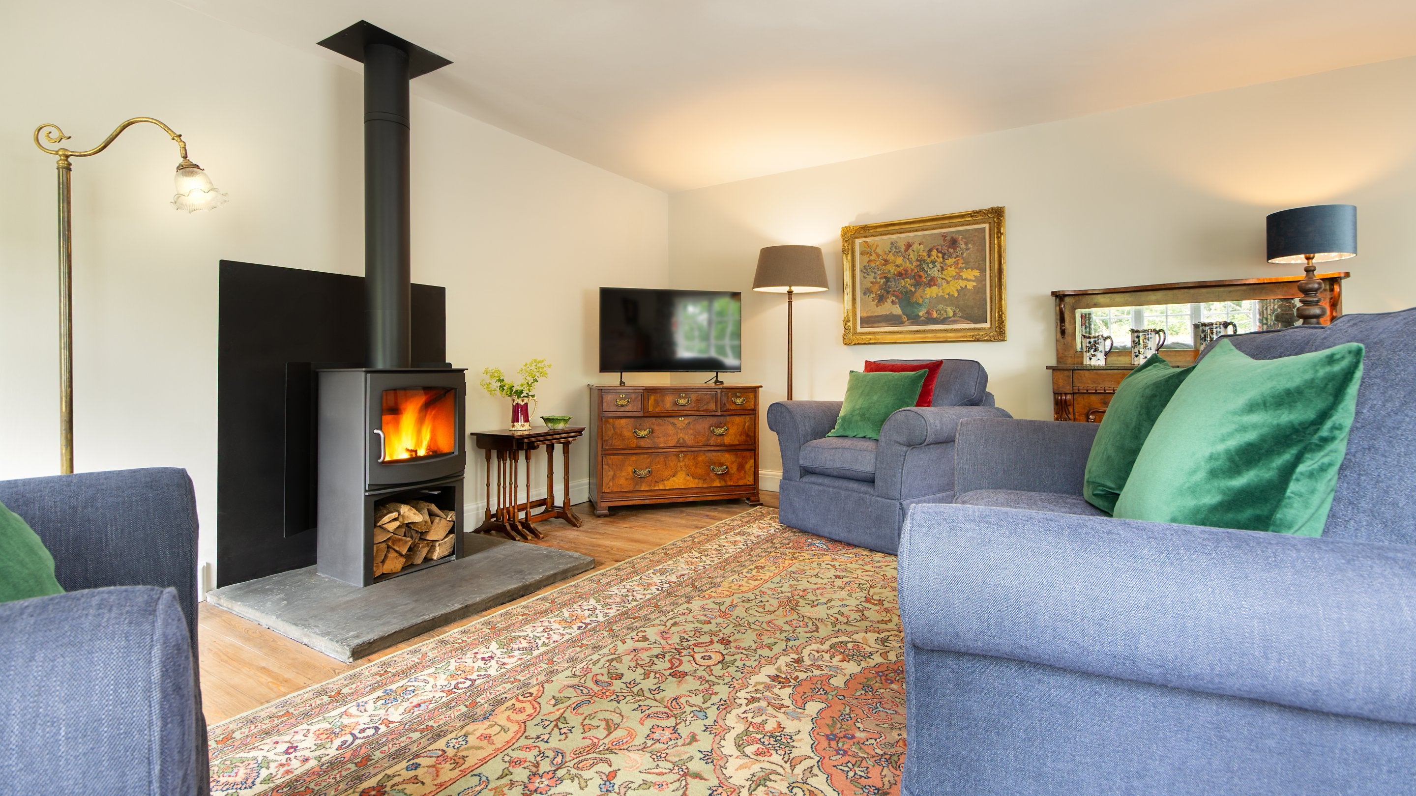 The open-plan sitting and dining room with woodburner at Cawdor, Pembrokeshire