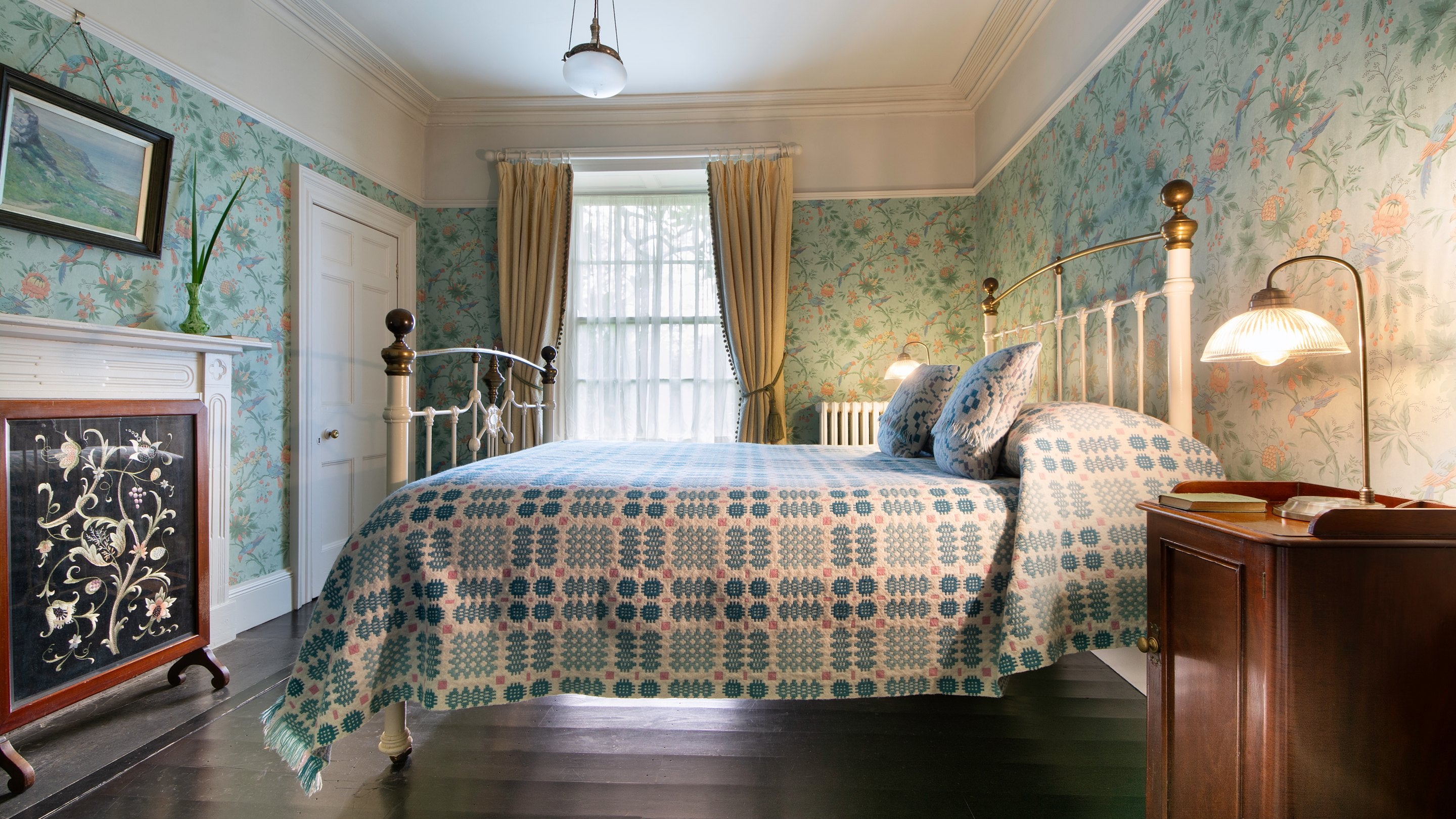 A double bedroom with antique brass/iron bed at Egryn, Wales