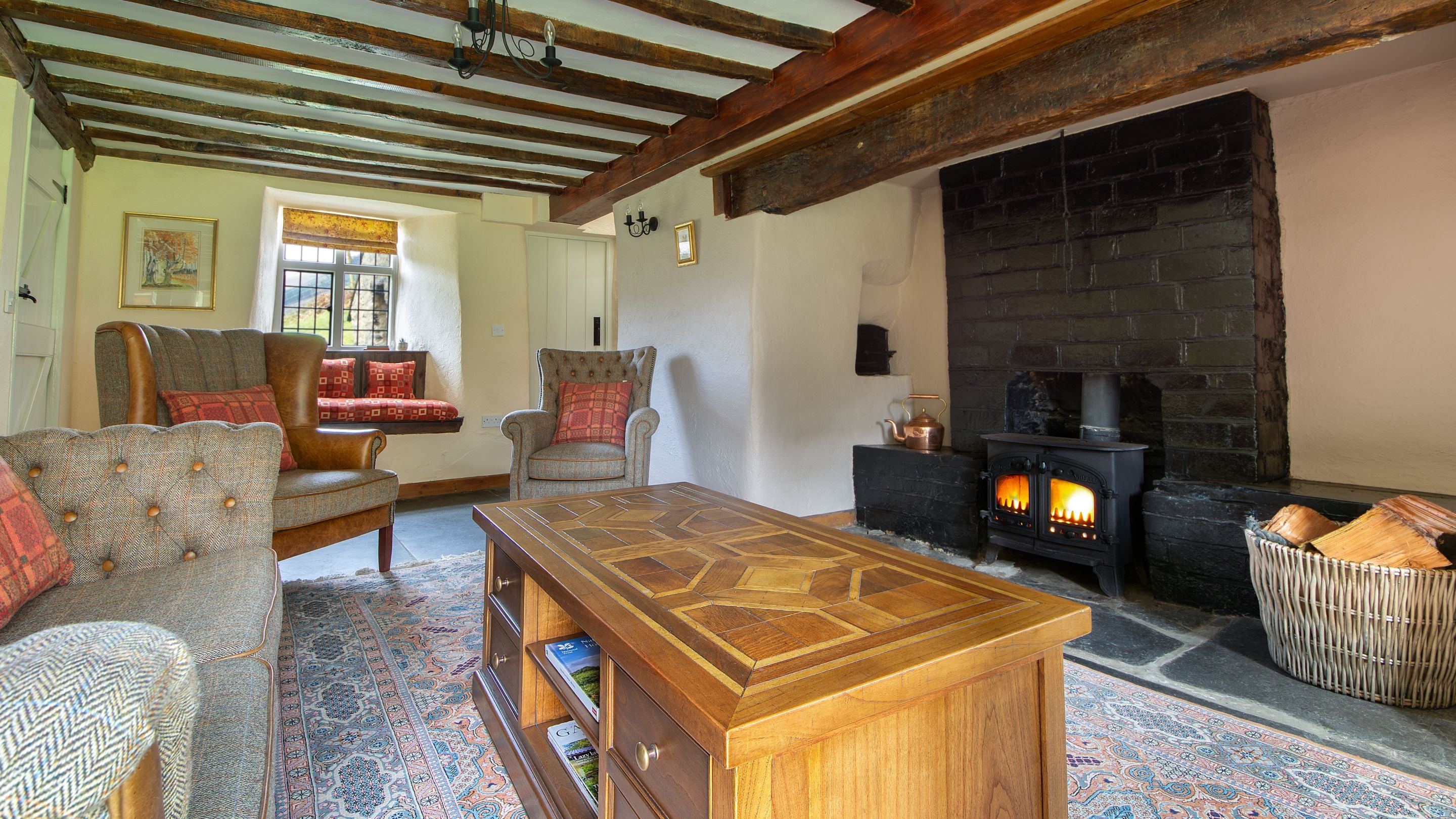 The sitting room with woodburner and window seats at Fron Dirion, Powys