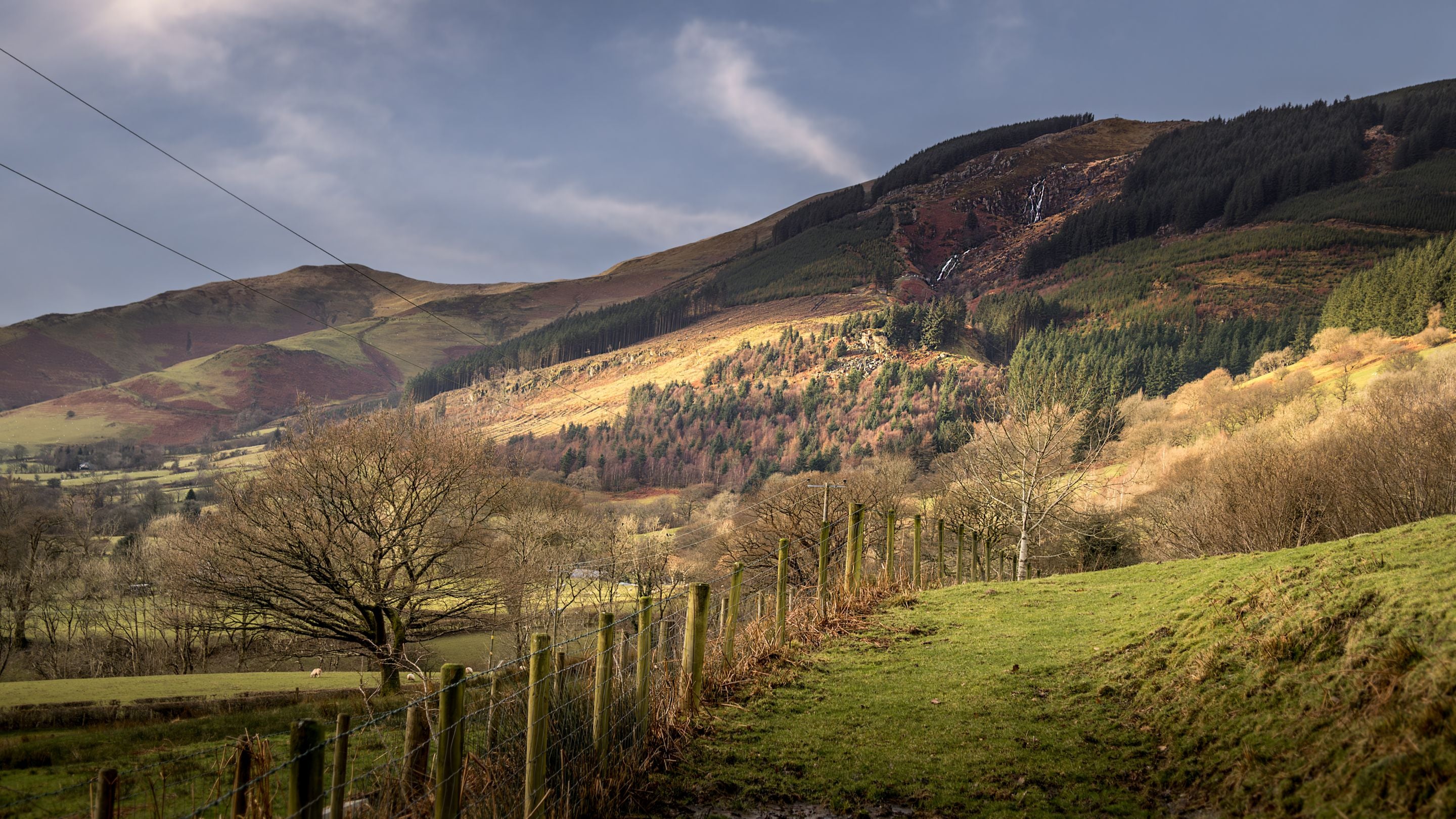 The countryside around Fron Dirion, with a waterfall in the distance, Powys