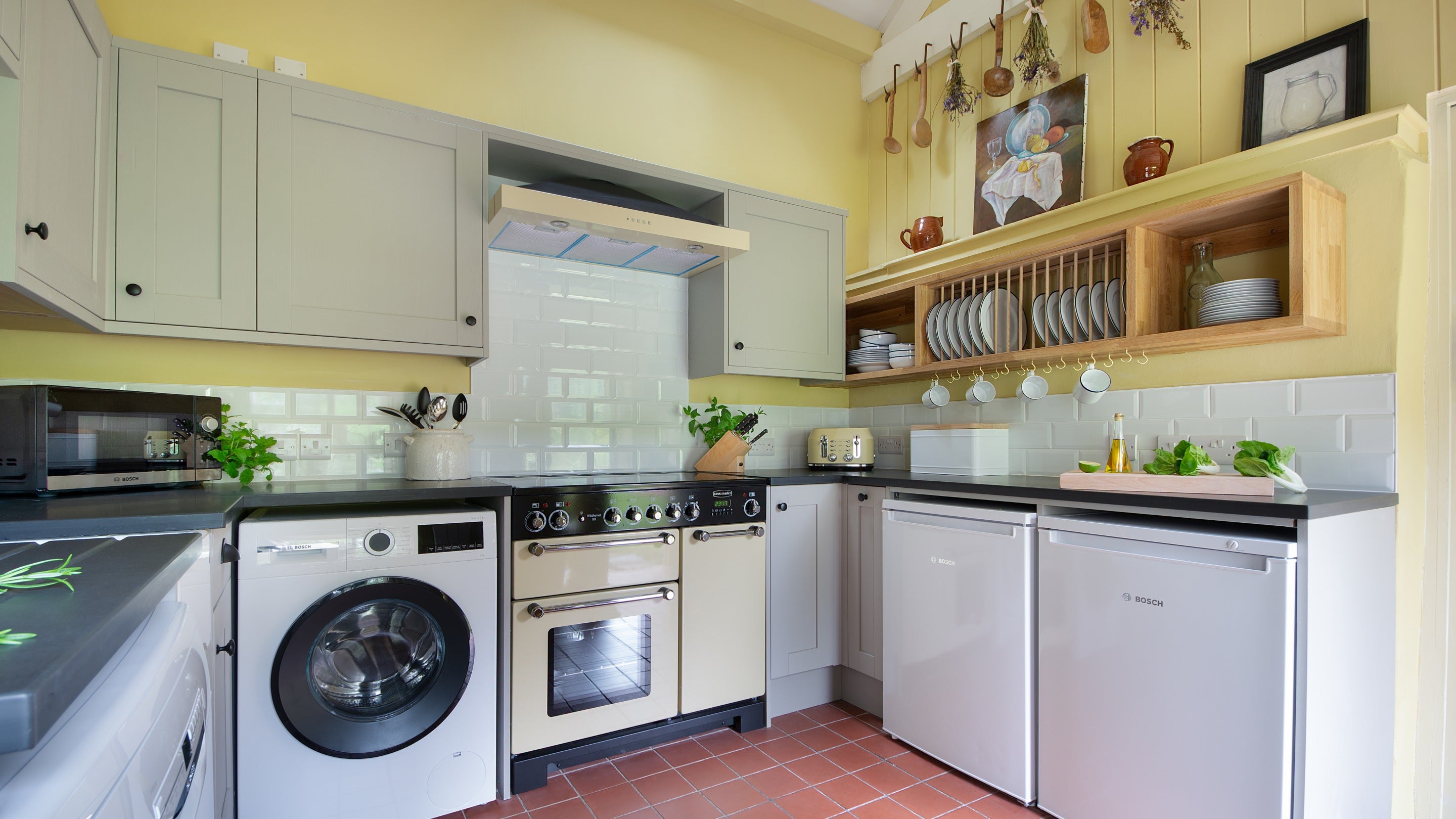 The kitchen with fridge, freezer, oven, hob, washing machine, micowave and toaster at Hawthorn Cottage, Ceredigion