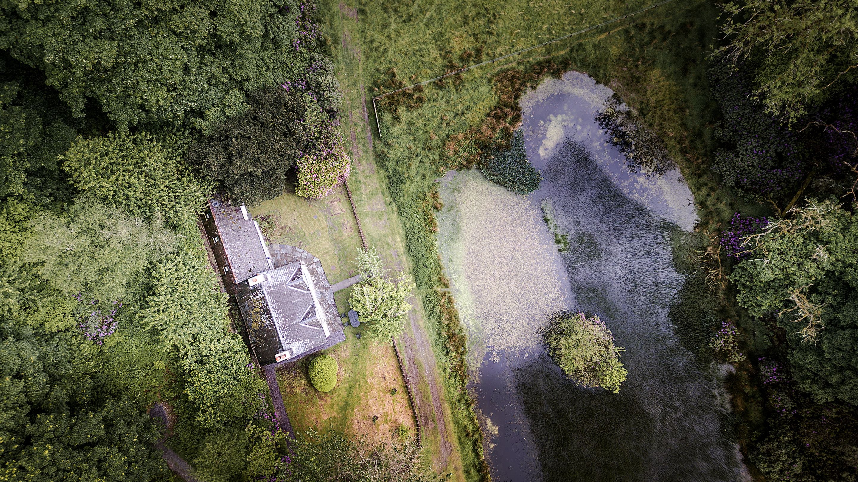 An aerial view of Hawthorn Cottage, Lady's Walk and the old duck pond, Ceredigion