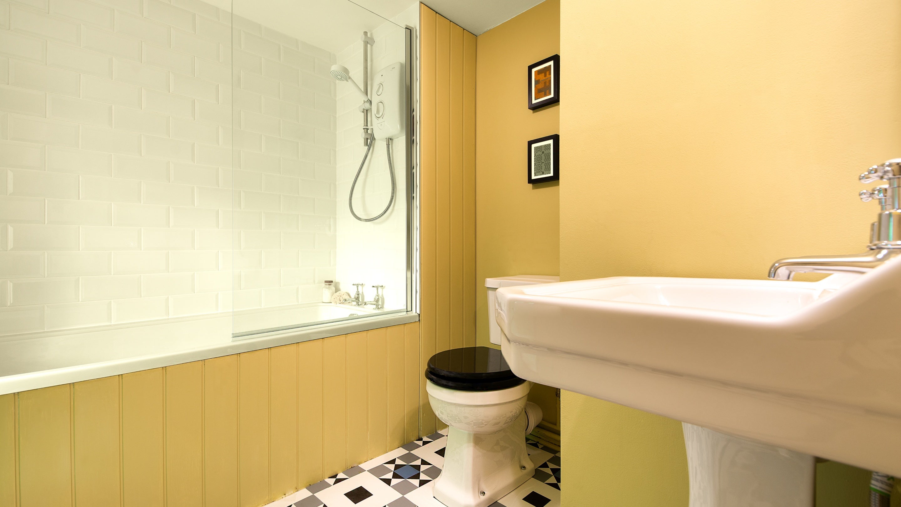 The bathroom with shower over bath at Hawthorn Cottage, Ceredigion