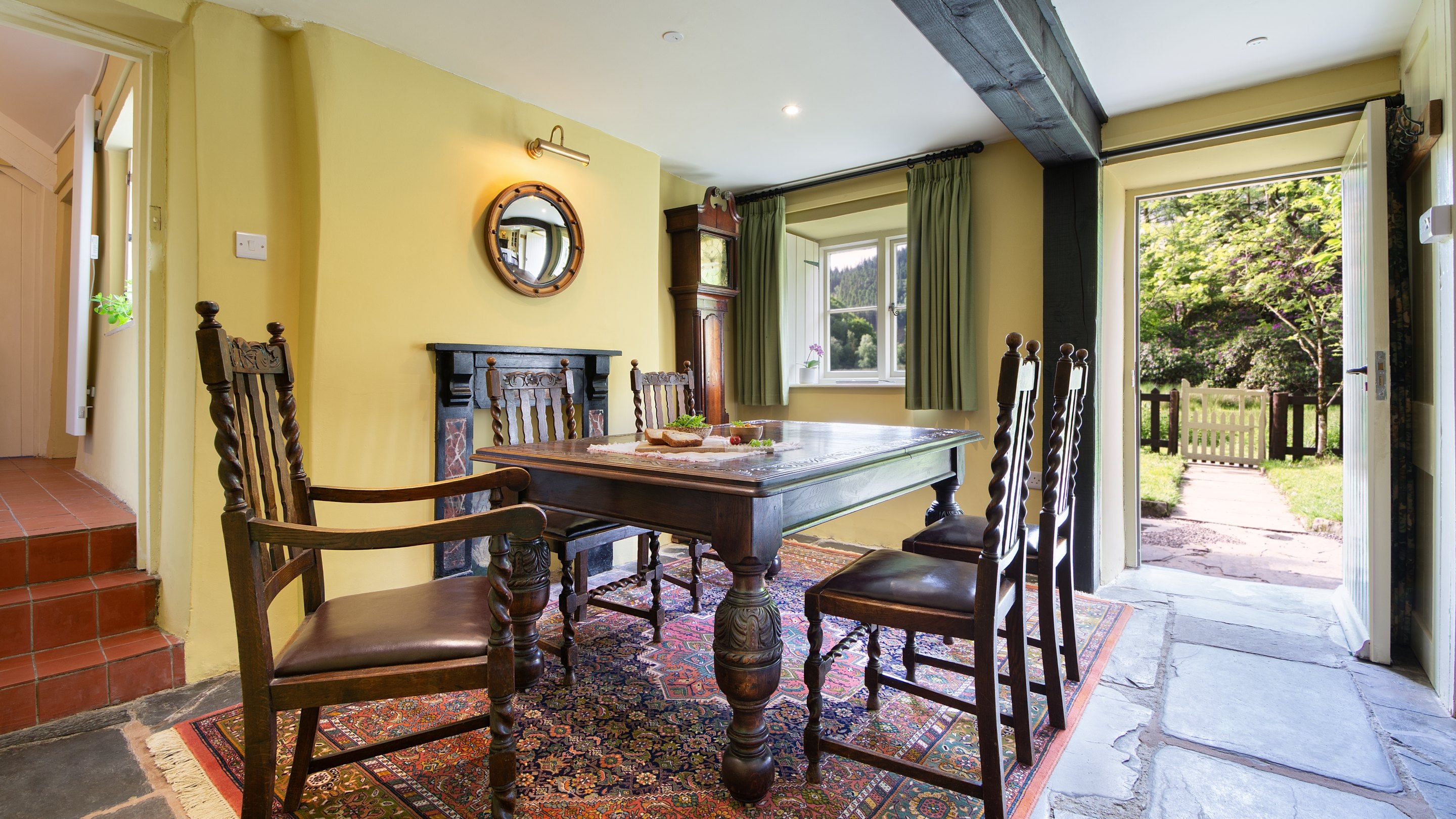 The dining area at Hawthorn Cottage, with yellow paint inspired by wild irises that grow in the pond, Ceredigion