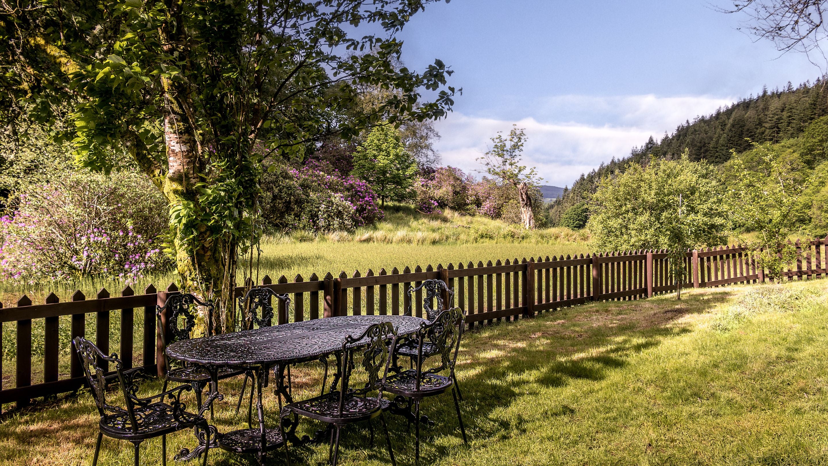 The garden with dining furniture for six people at Hawthorn Cottage, Ceredigion