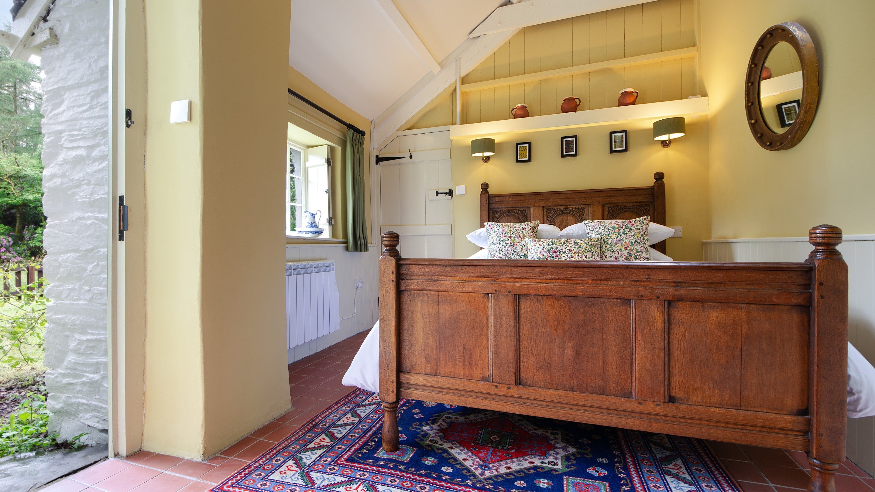 The ground floor double bedroom with en-suite shower room and external door at Hawthorn Cottage, Ceredigion