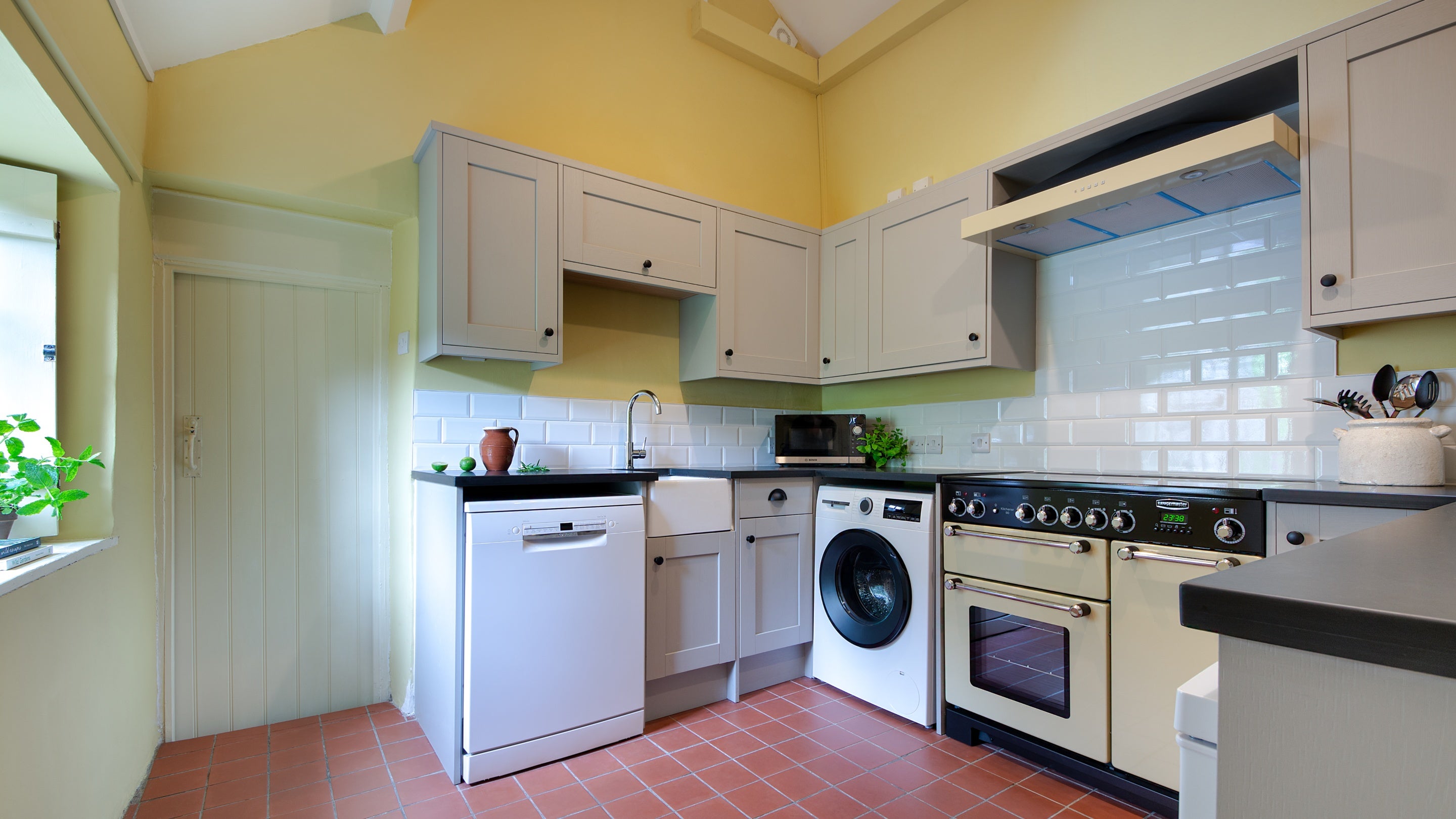 The kitchen at Hawthorn Cottage, with dishwasher, washing machine, oven, hob and microwave, Ceredigion