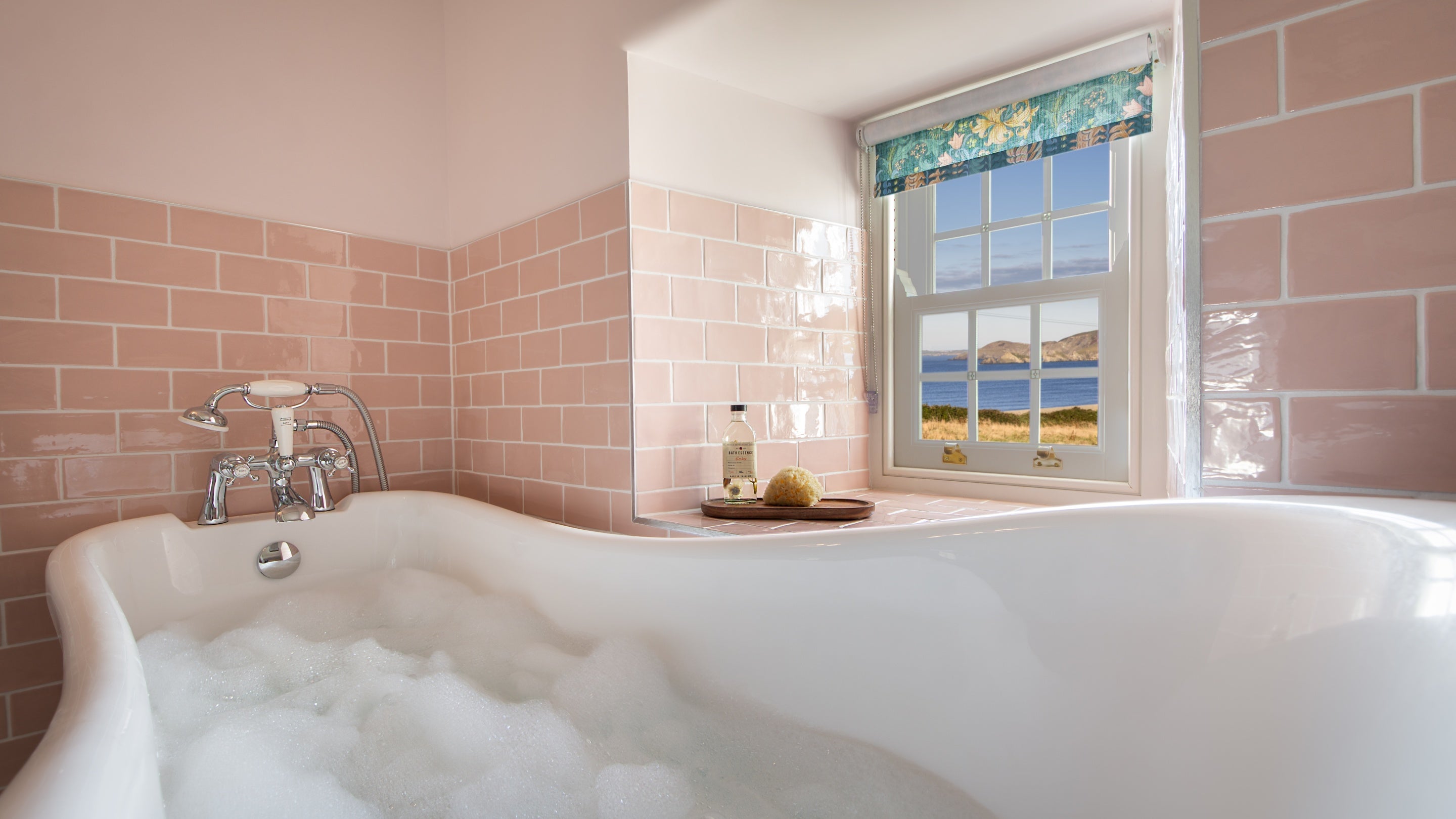 The king-size bedroom's en-suite bathroom at Newgale Wood Farm, with sea views from the bath, Pembrokeshire
