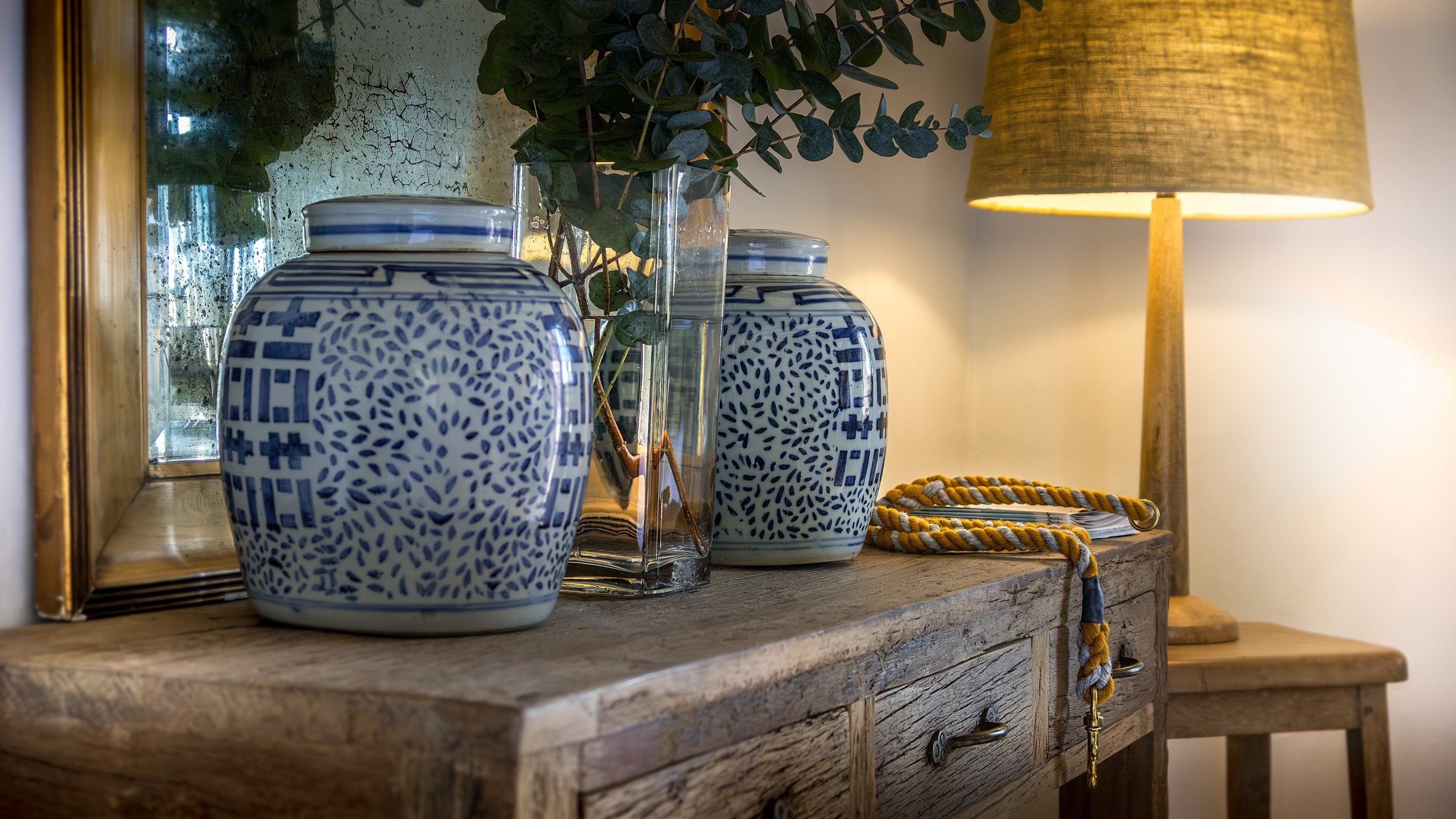 A wooden side table with decorative vases at Newgale Wood Farm, Pembrokeshire