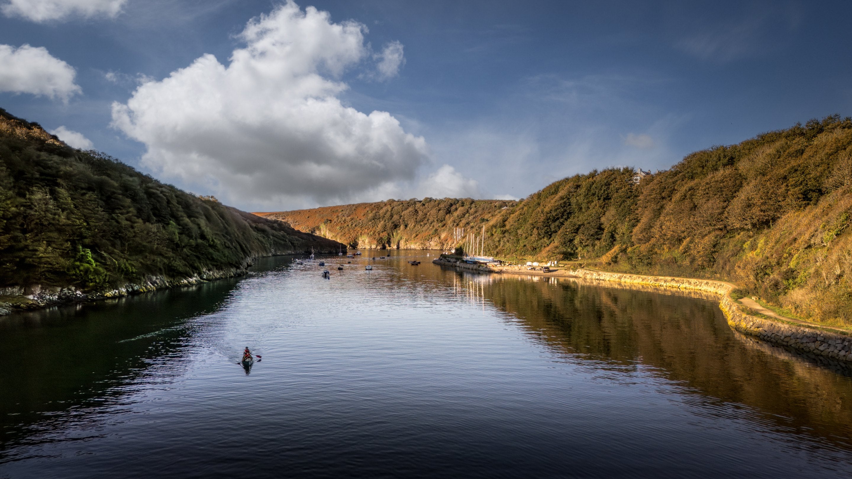 An aerial view of a kayaker on the River Solva at Solva Harbour, Pembrokeshire