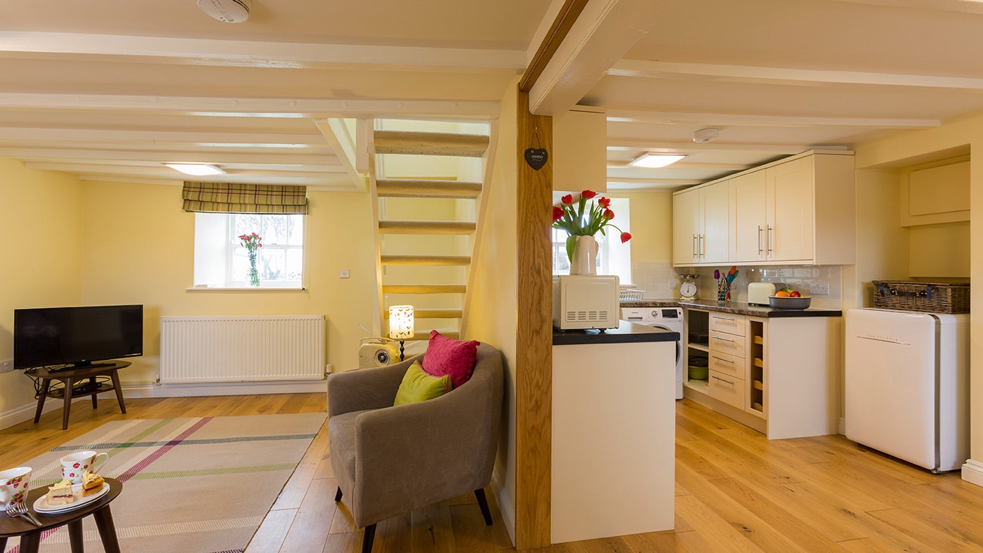 The sitting room and kitchen at Penrhyn Mawr, Gwynedd