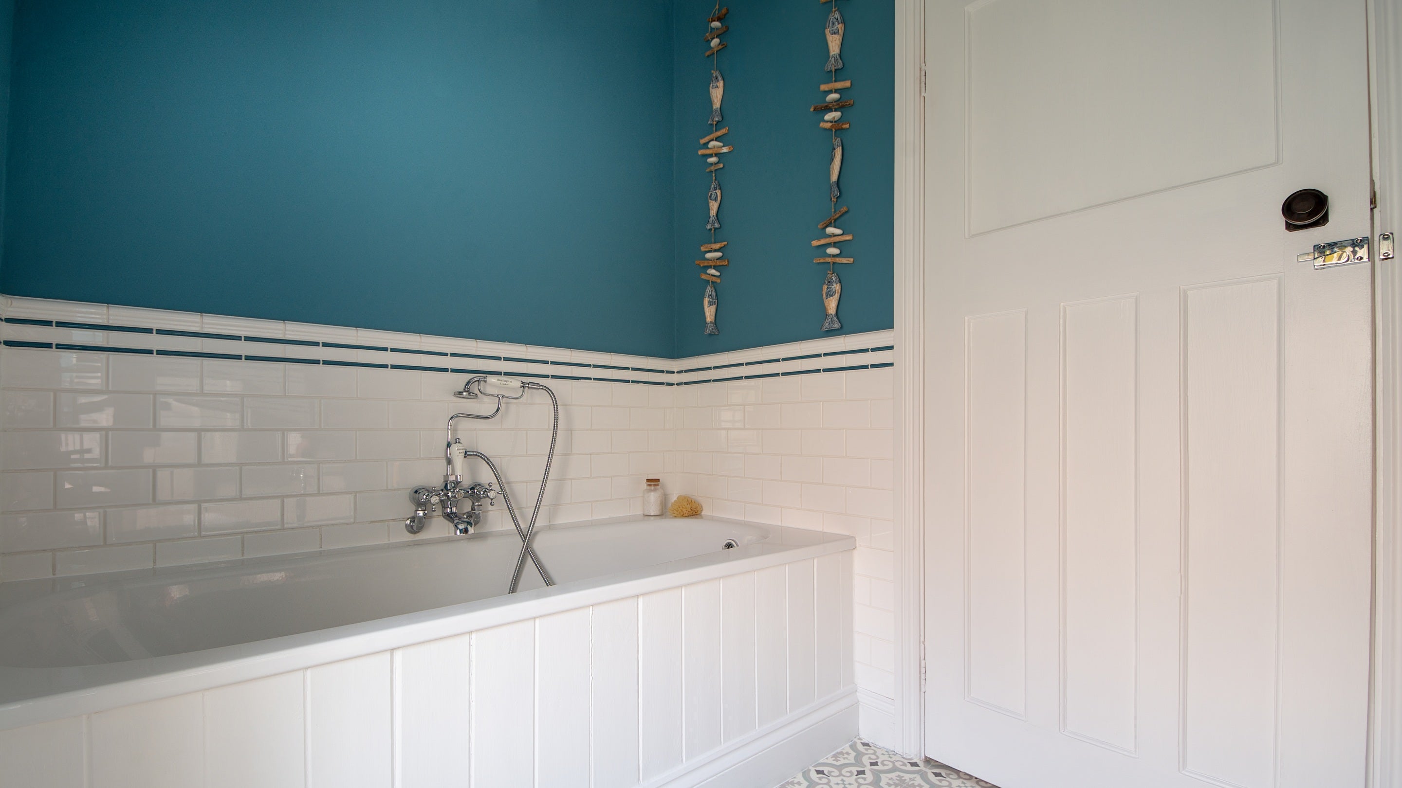 The bathroom with bath with shower attachment, at Rhossili Old Rectory, South Wales