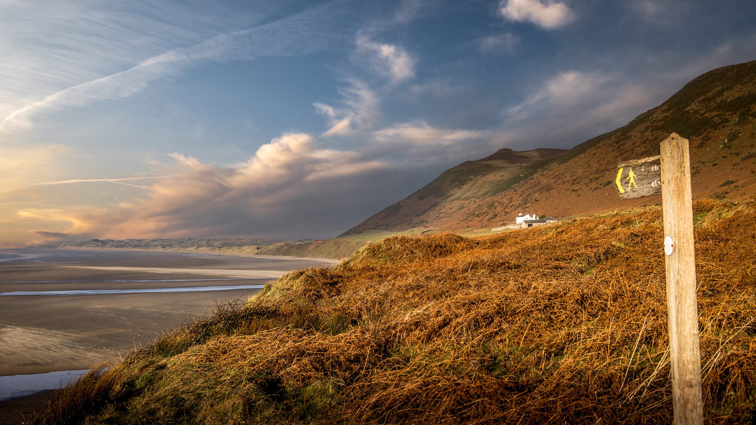 A footpath to Rhossili Bay Beach, with Rhossili Old Rectory in the background, South Wales