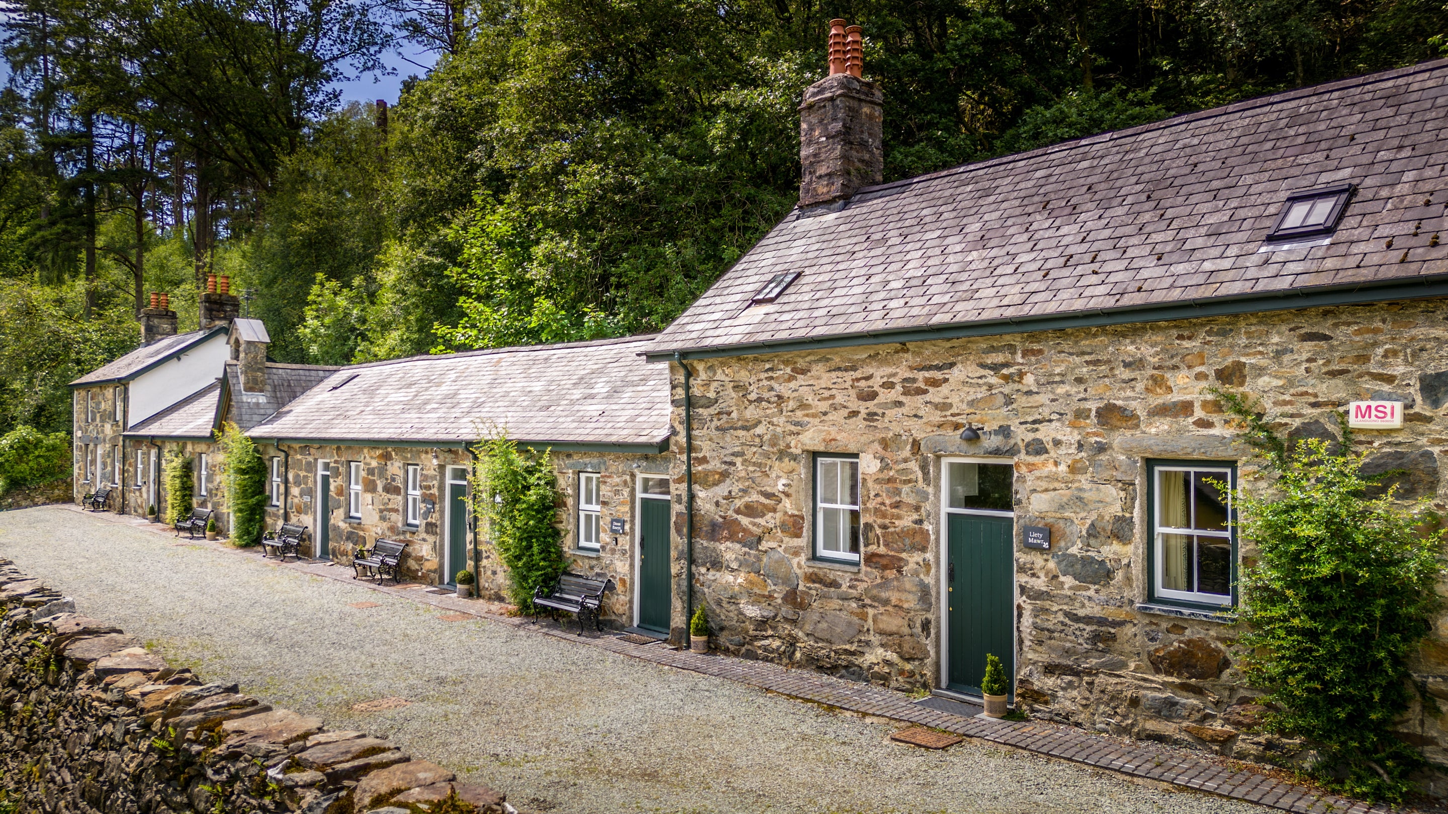 The row of cottages at Craflwyn Hall, including Stabl Bach, Gwynedd