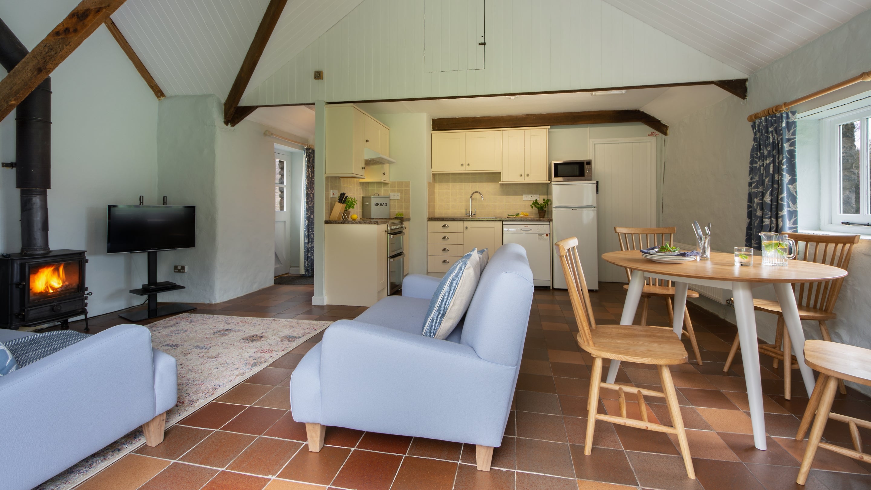 The open plan sitting, kitchen and dining room at Stackpole Byre 2, Pembrokeshire