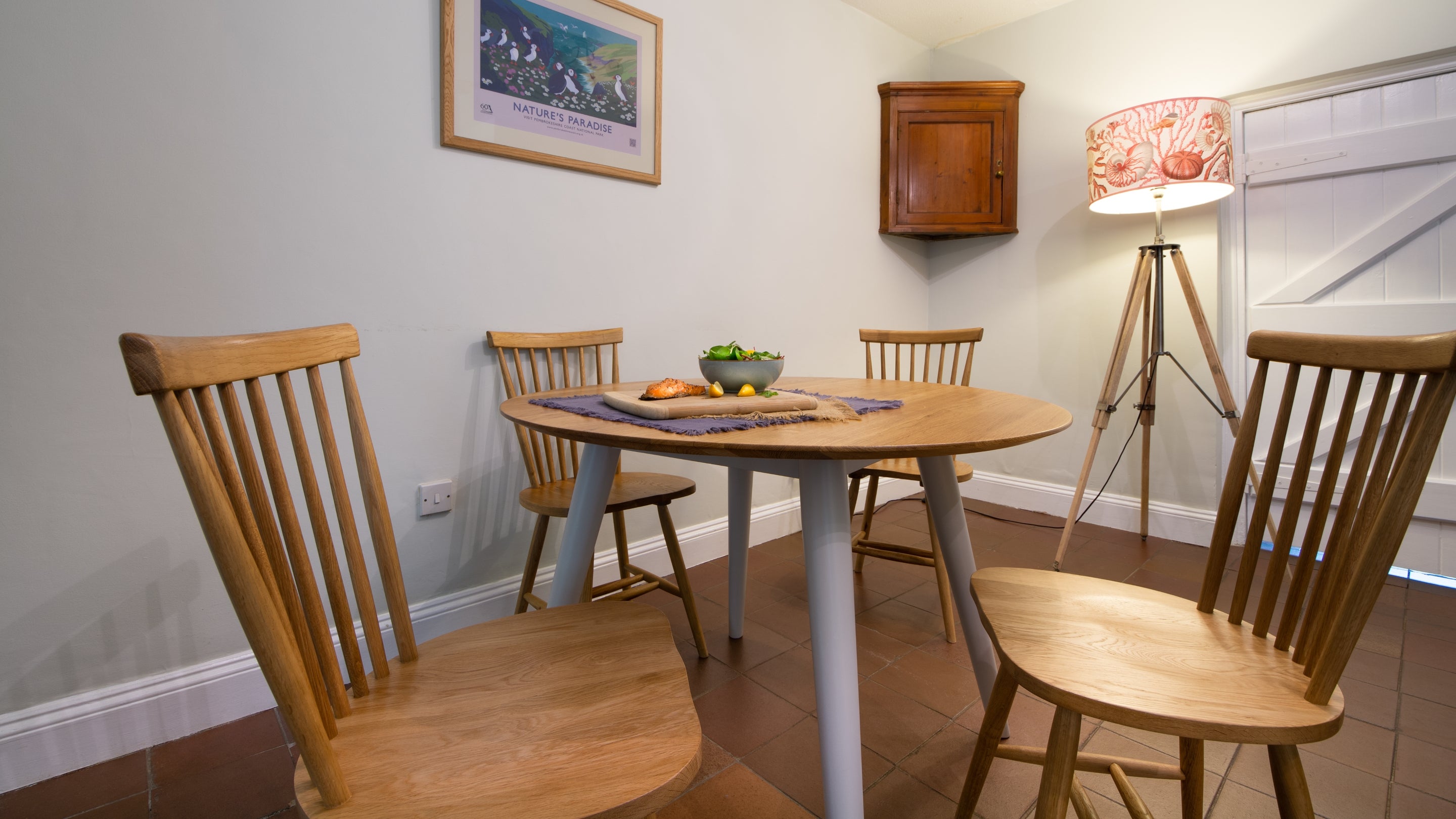 The sitting and dining room at Stackpole Quay Cottage 1, Pembrokeshire