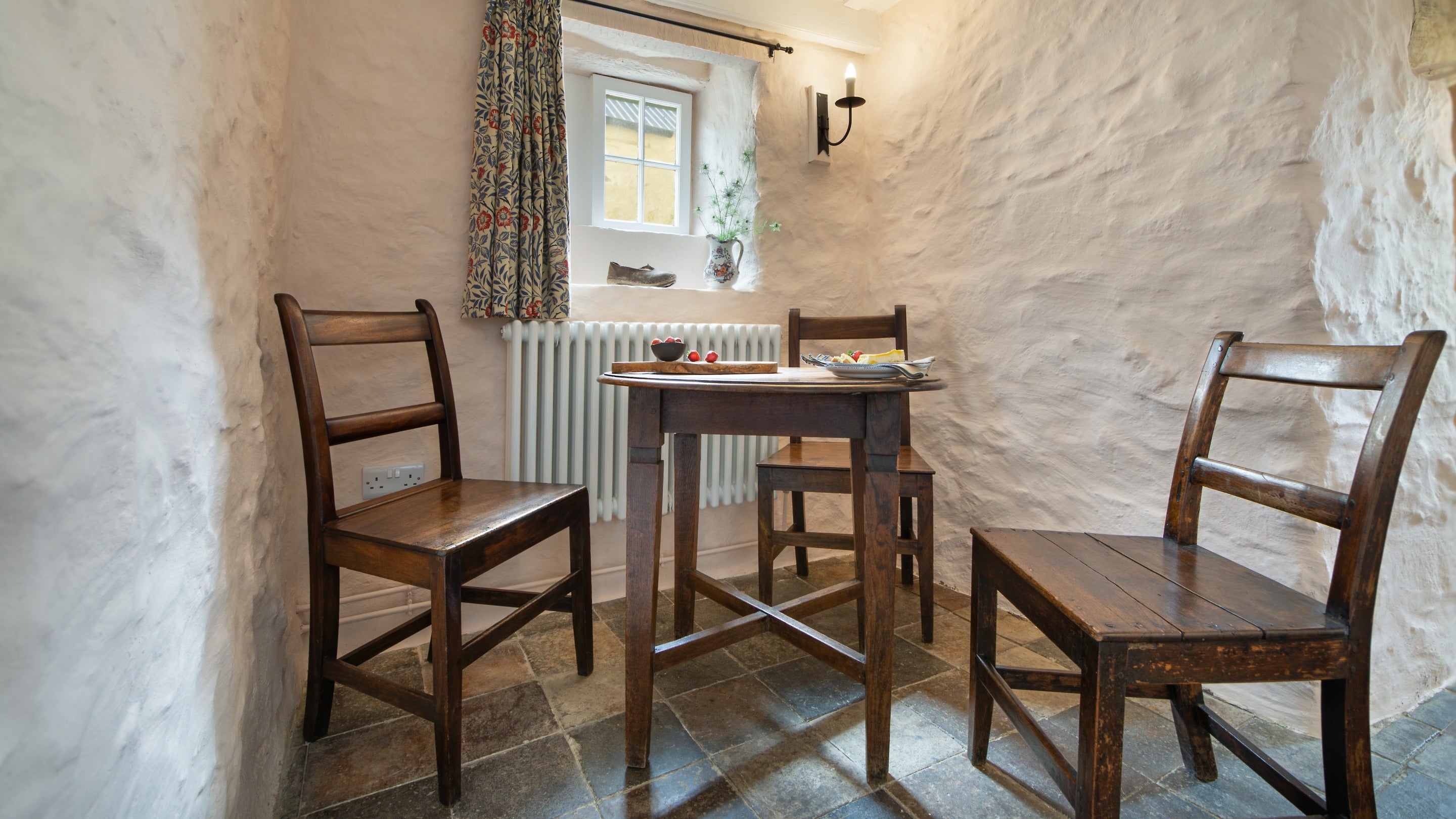 The table in the sitting and dining room at Treleddyd Fawr Cottage, Pembrokeshire
