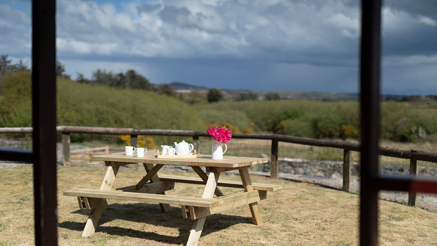 The seating area for Ty'n y Parc Barn in the shared garden with Ty'n y Parc Farmhouse, Gwynedd, Wales