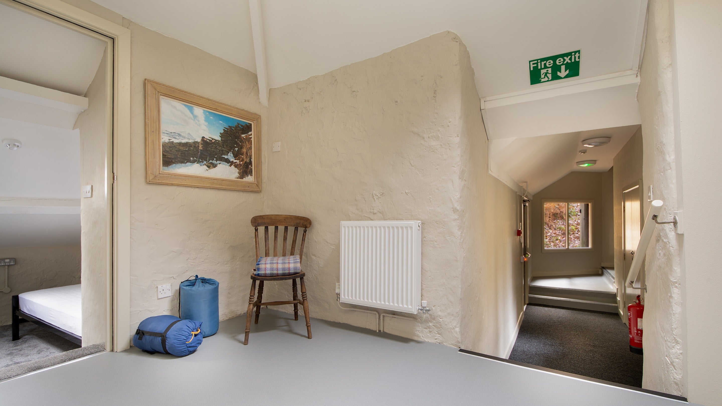 The hallway on the first floor of Watkin Bunkhouse, with steps between different levels, Gwynedd