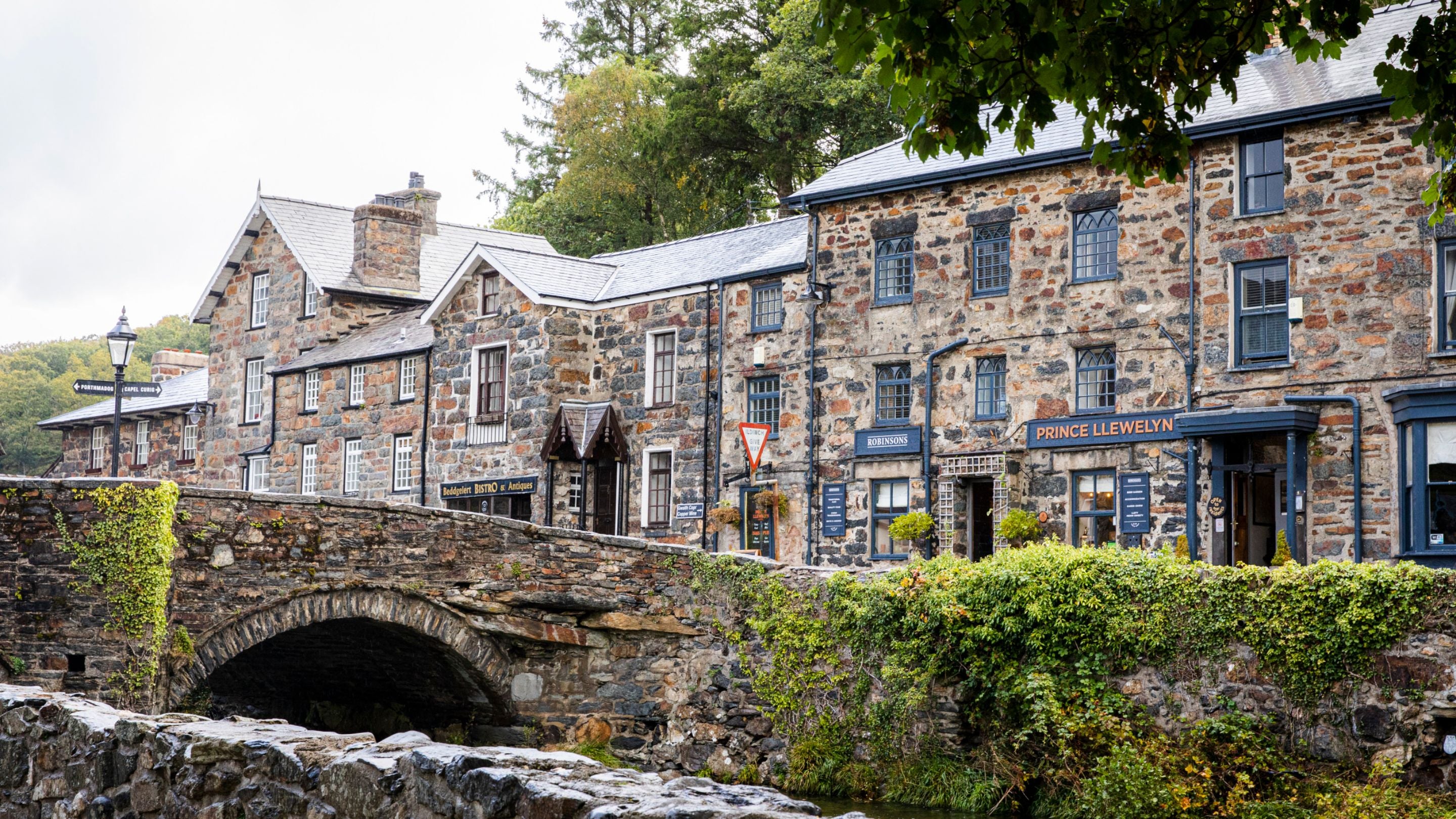 Stone buildings and bridge over the River Colwyn at Beddgelert, near Watkin Bunkhouse, Gwynedd