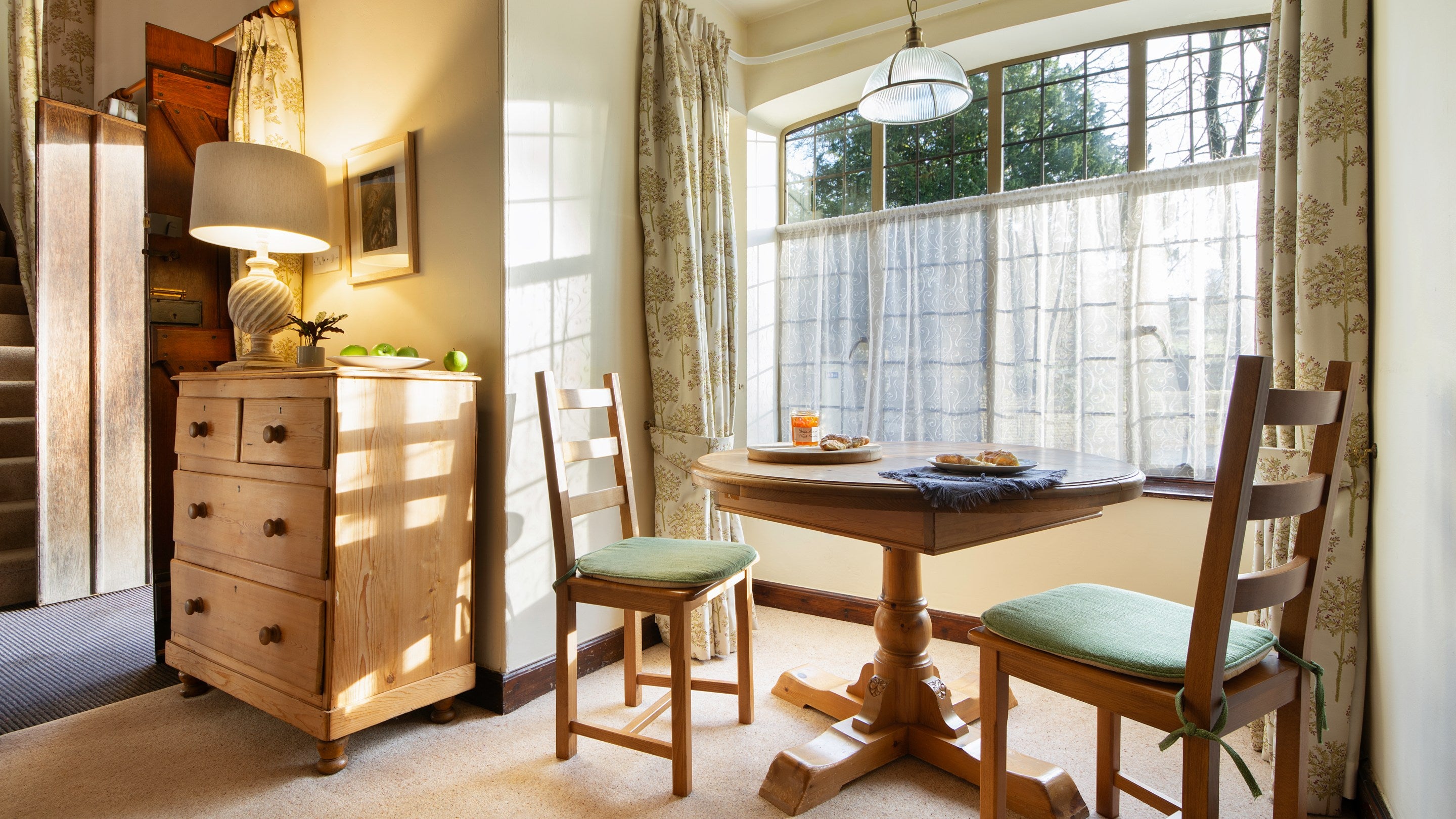 The dining area for two in the open-plan sitting and dining room at Abbey Stores, North Yorkshire