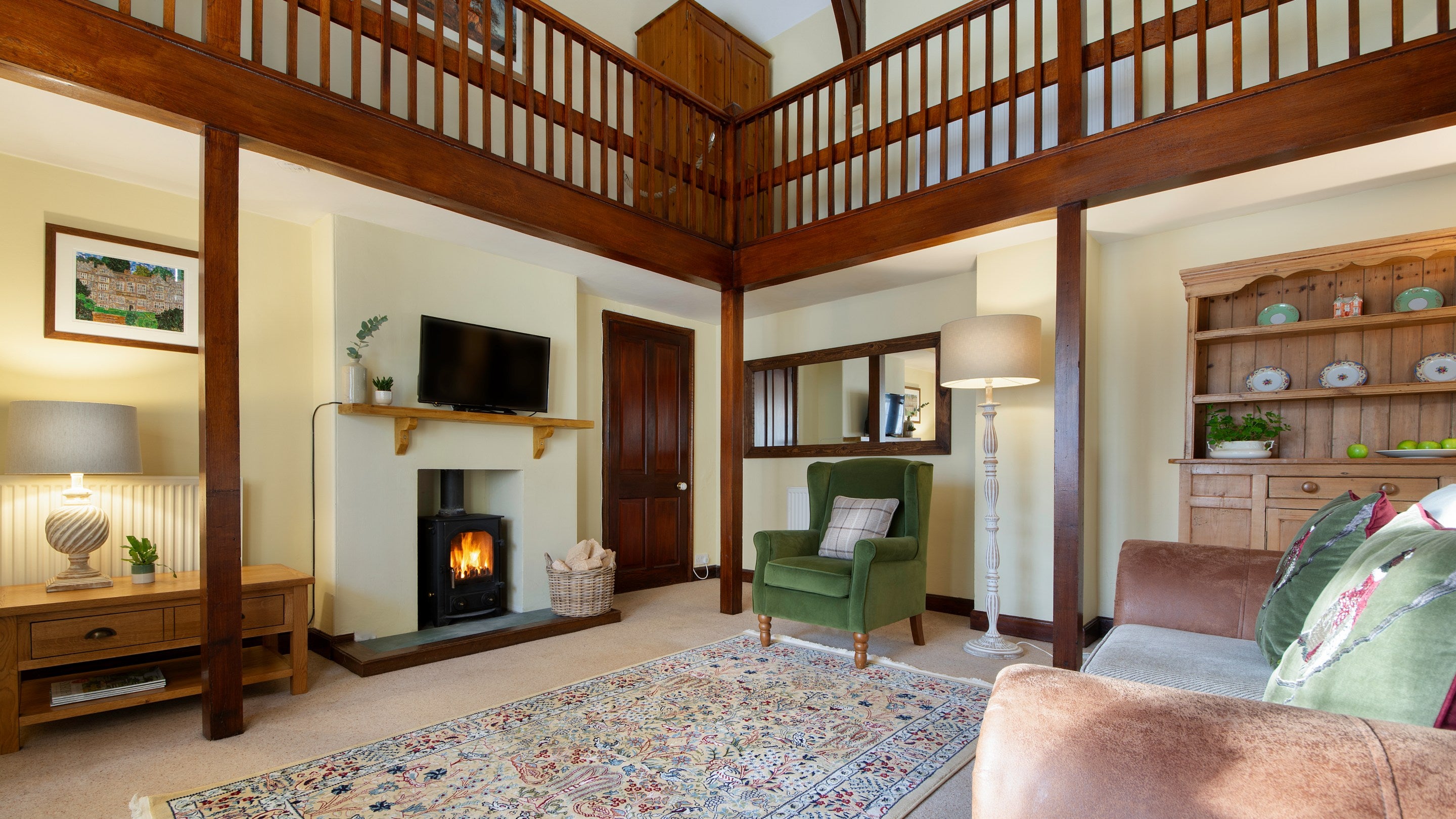 The sitting room with wood burning stove and television at Abbey Stores, North Yorkshire