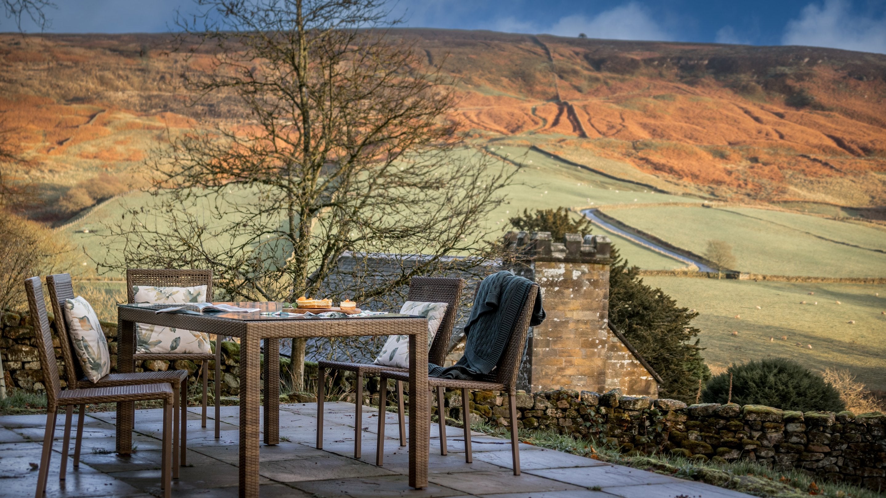 The patio with outdoor table and chairs at Cockayne Cottage in winter, Yorkshire