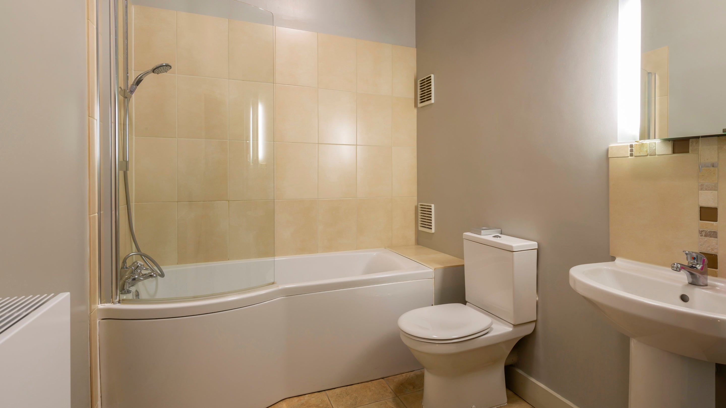 The bathroom with shower over bath on the first-floor of Curlew, Yorkshire