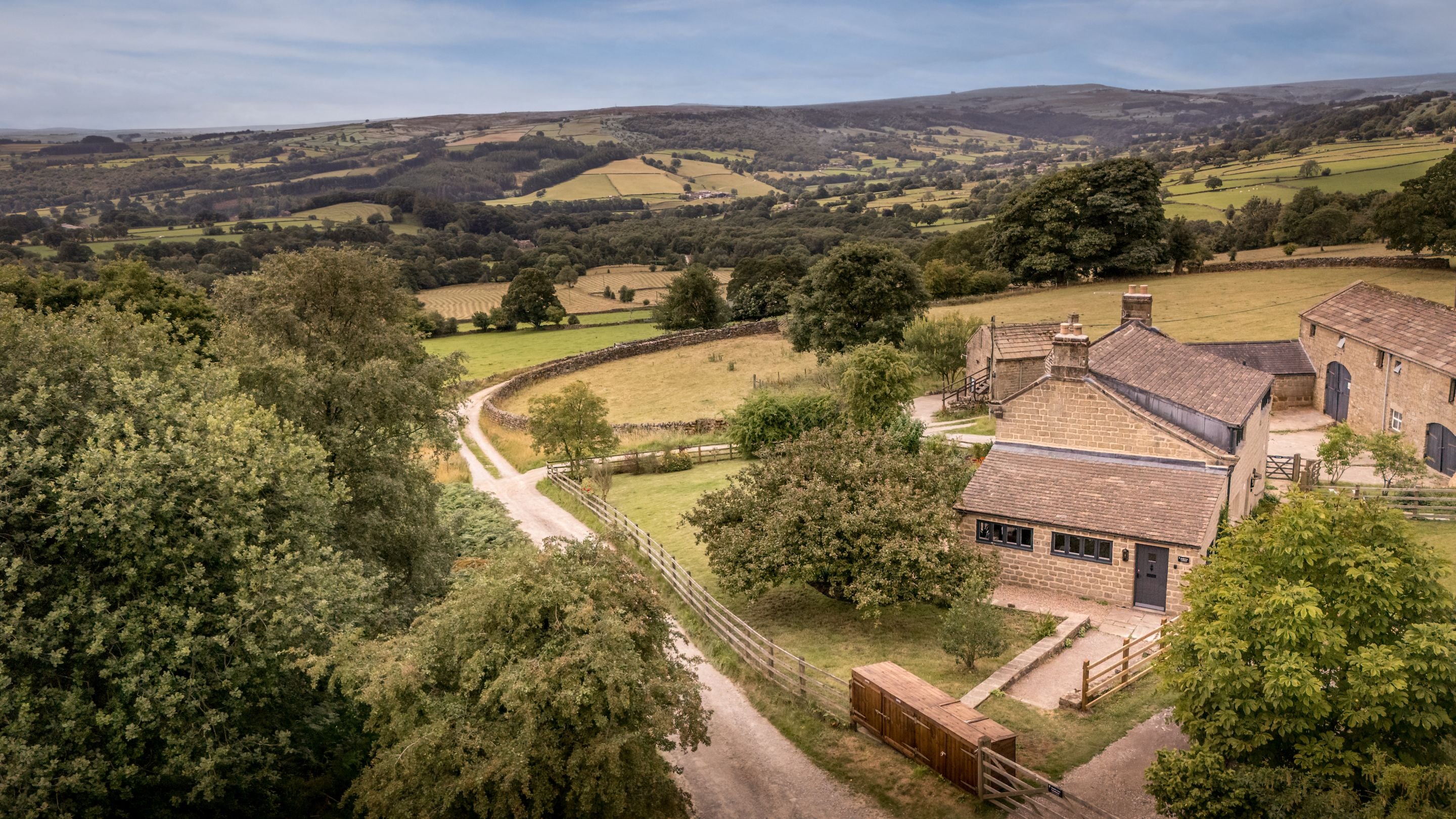 An aerial view of side of Druid's Cave Farmhouse and the countryside beyond, North Yorkshire
