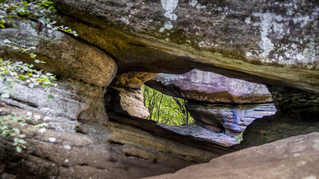 Close up of a hole through one of the rocks at Brimham Rocks, with a view of other formations beyond, North Yorkshire