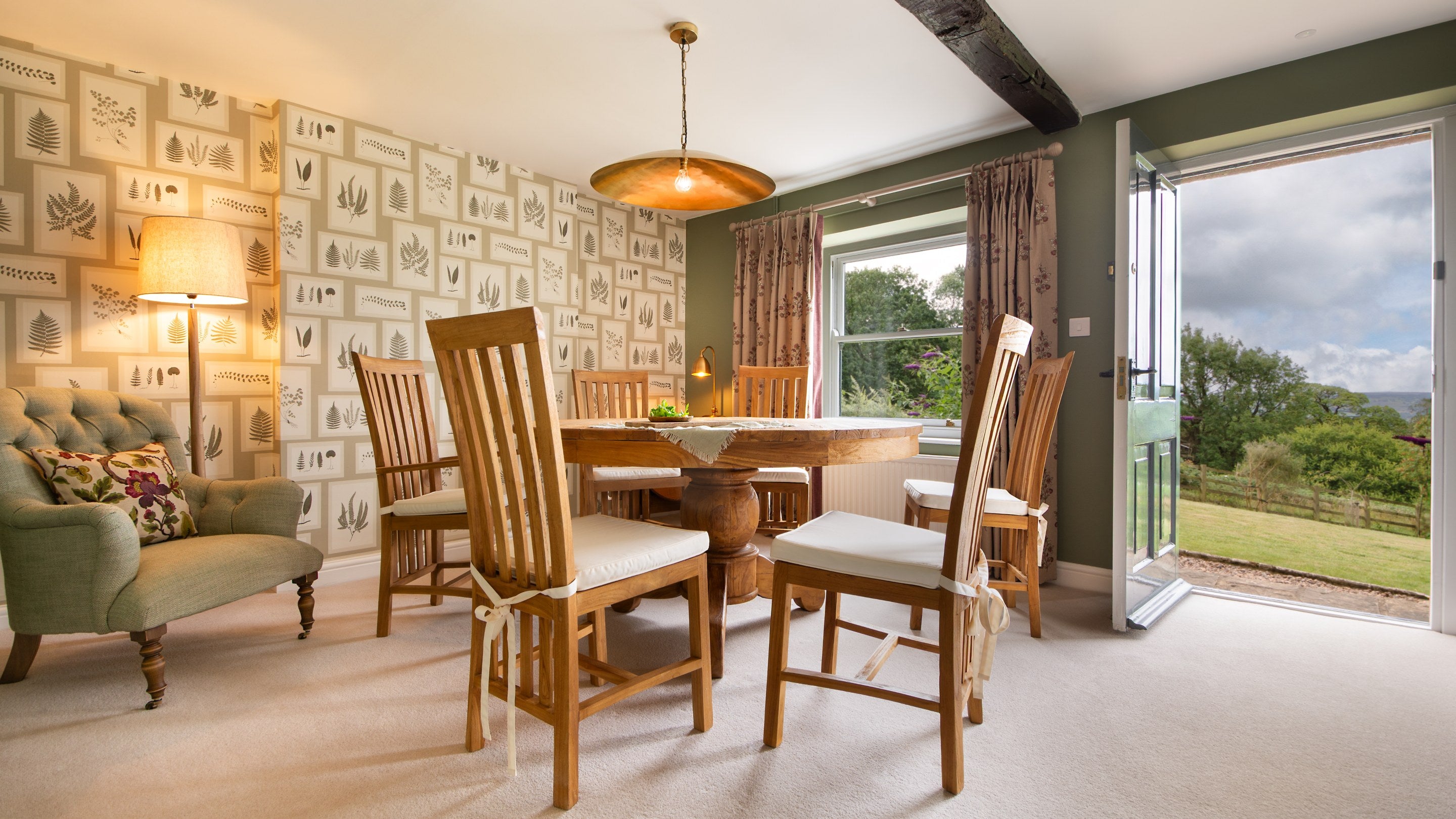 The dining room at Druid's Cave Farmhouse, with external door to garden patio, North Yorkshire