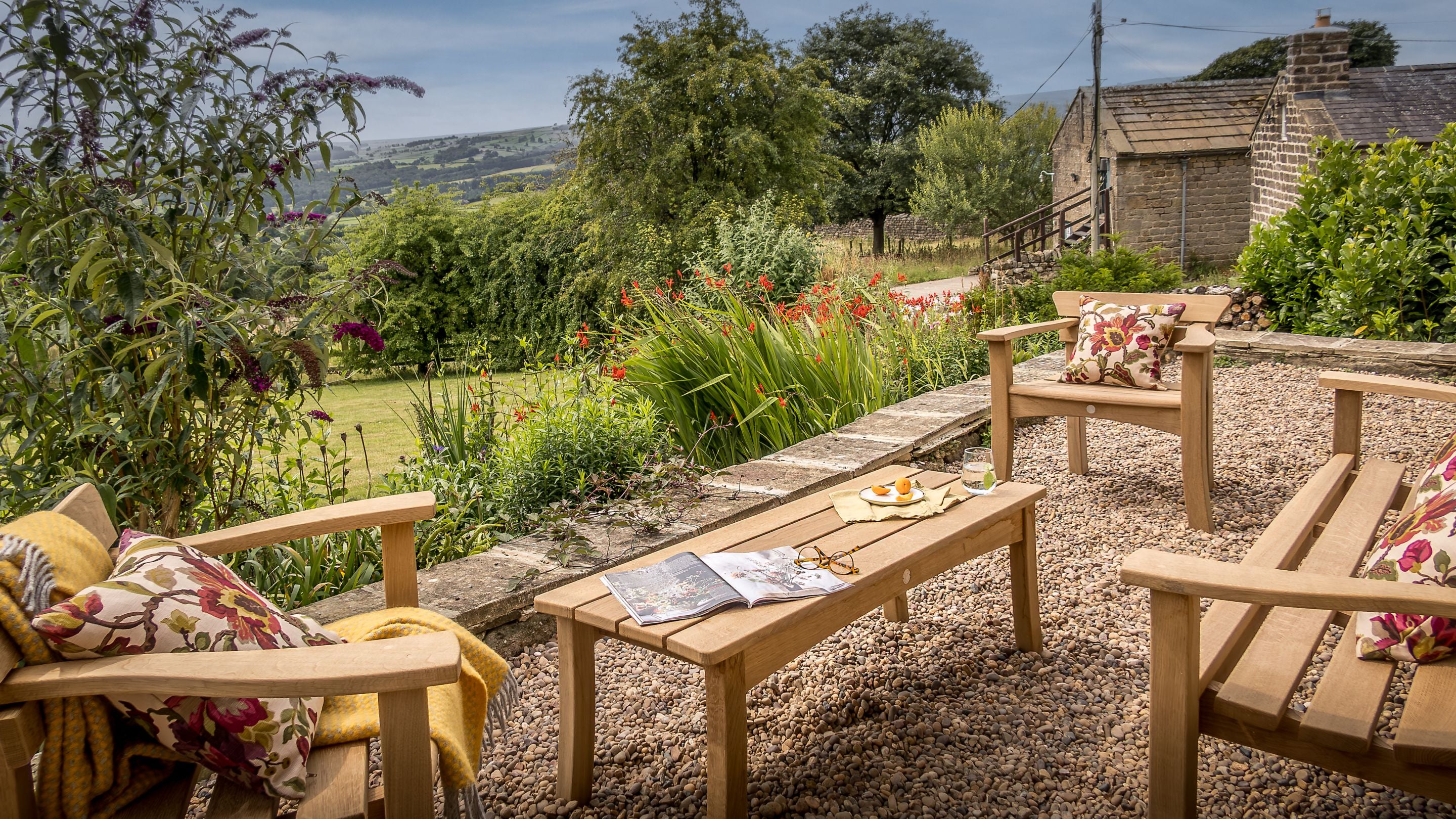 The gravelled patio at Druid's Cave Farmhouse, with table and chairs, North Yorkshire