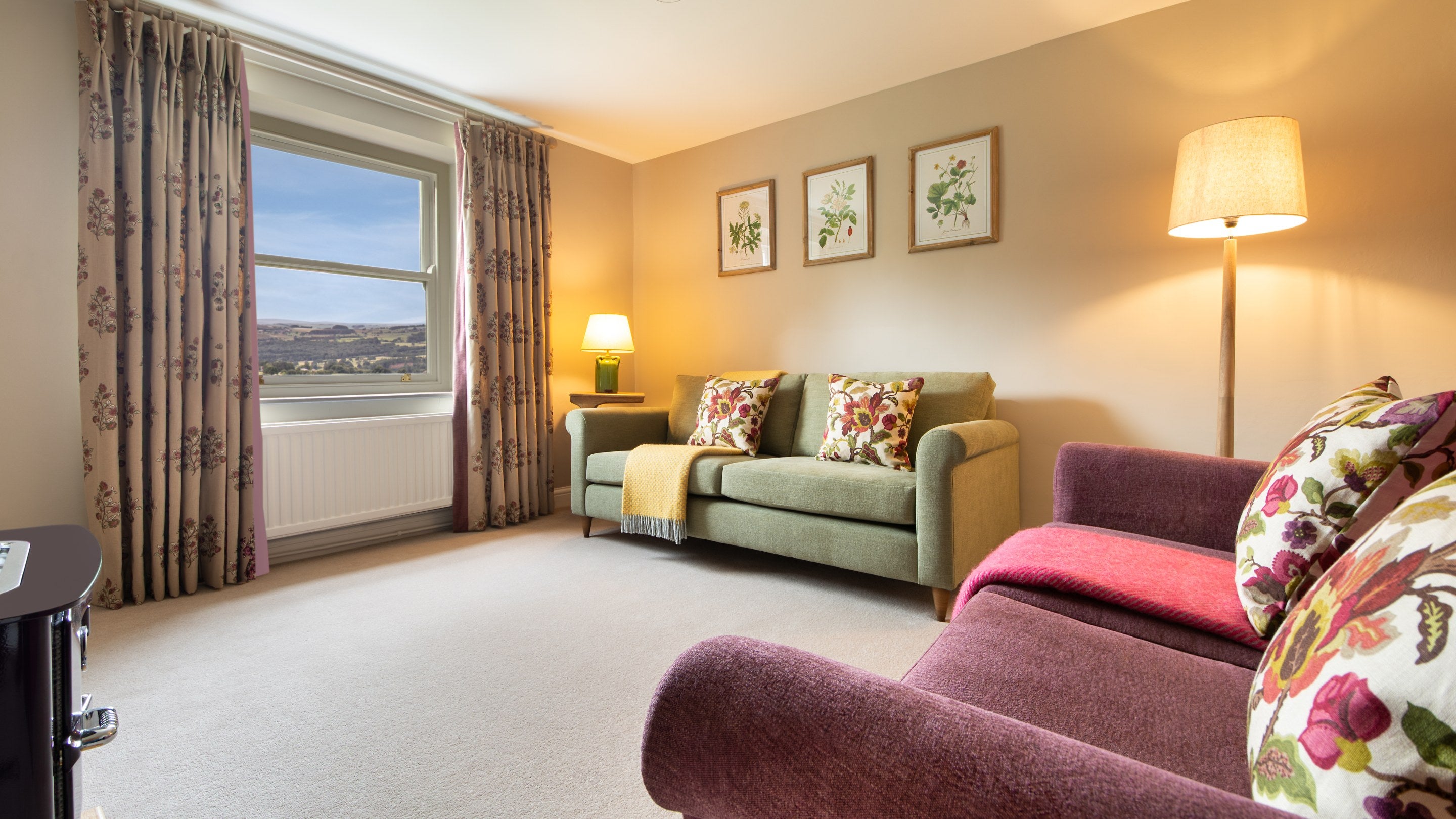 The sitting room at Druid's Cave Farmhouse with Everhot stove and countryside views, North Yorkshire