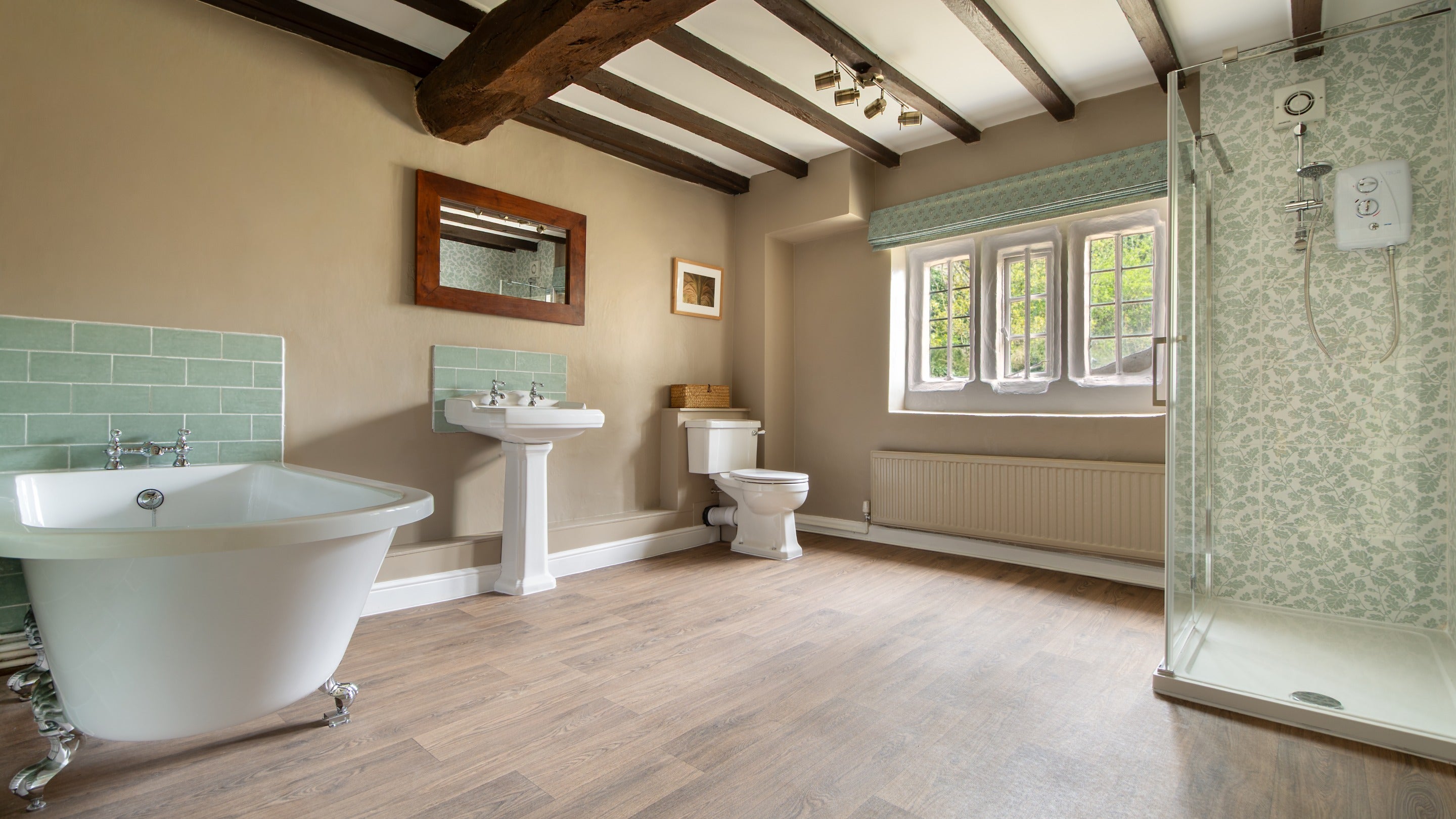 The first-floor bathroom at Fountains Cottage, with bath and walk-in shower, Yorkshire