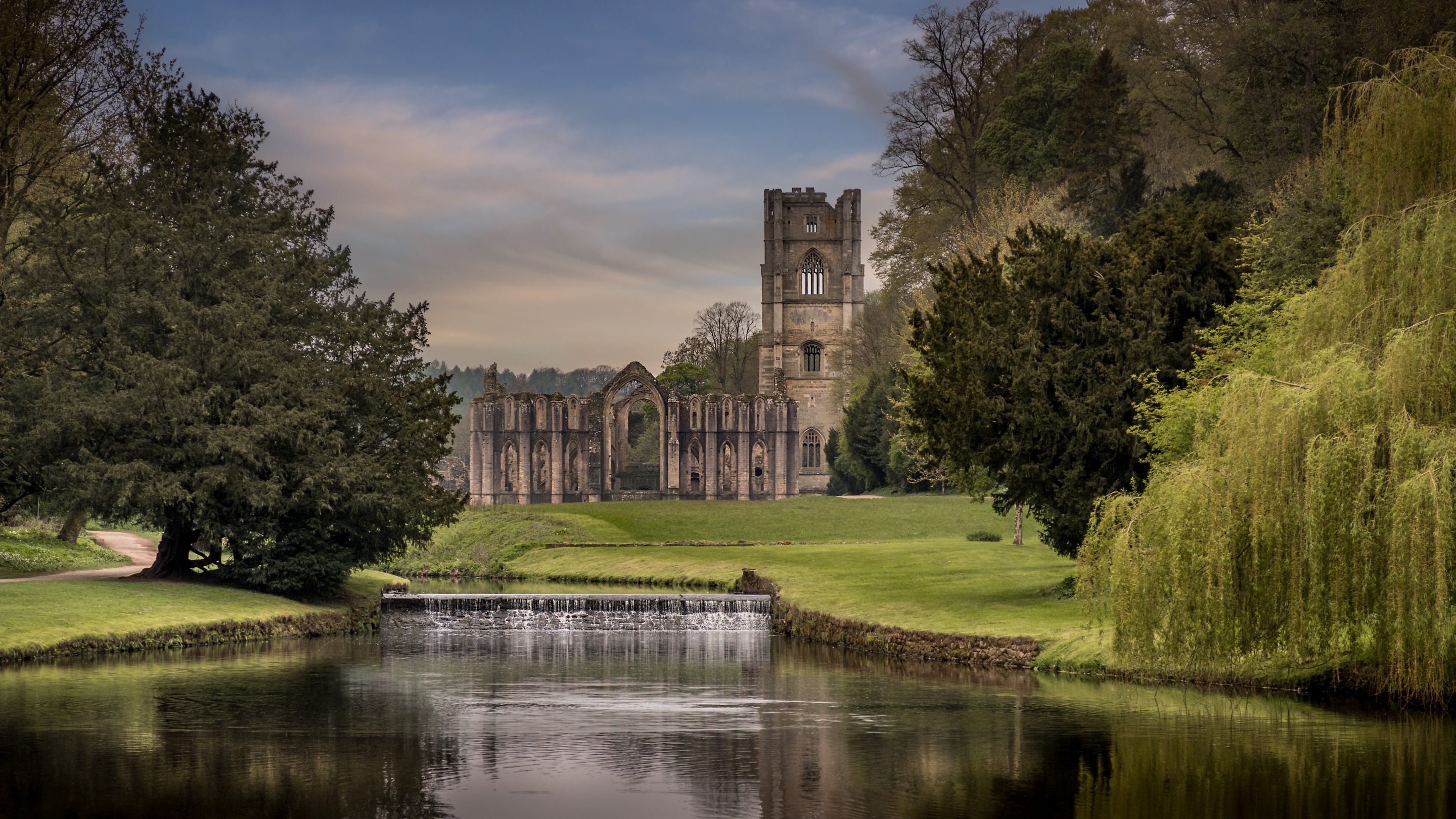 The ruins of Fountains Abbey and the River Skell, Yorkshire